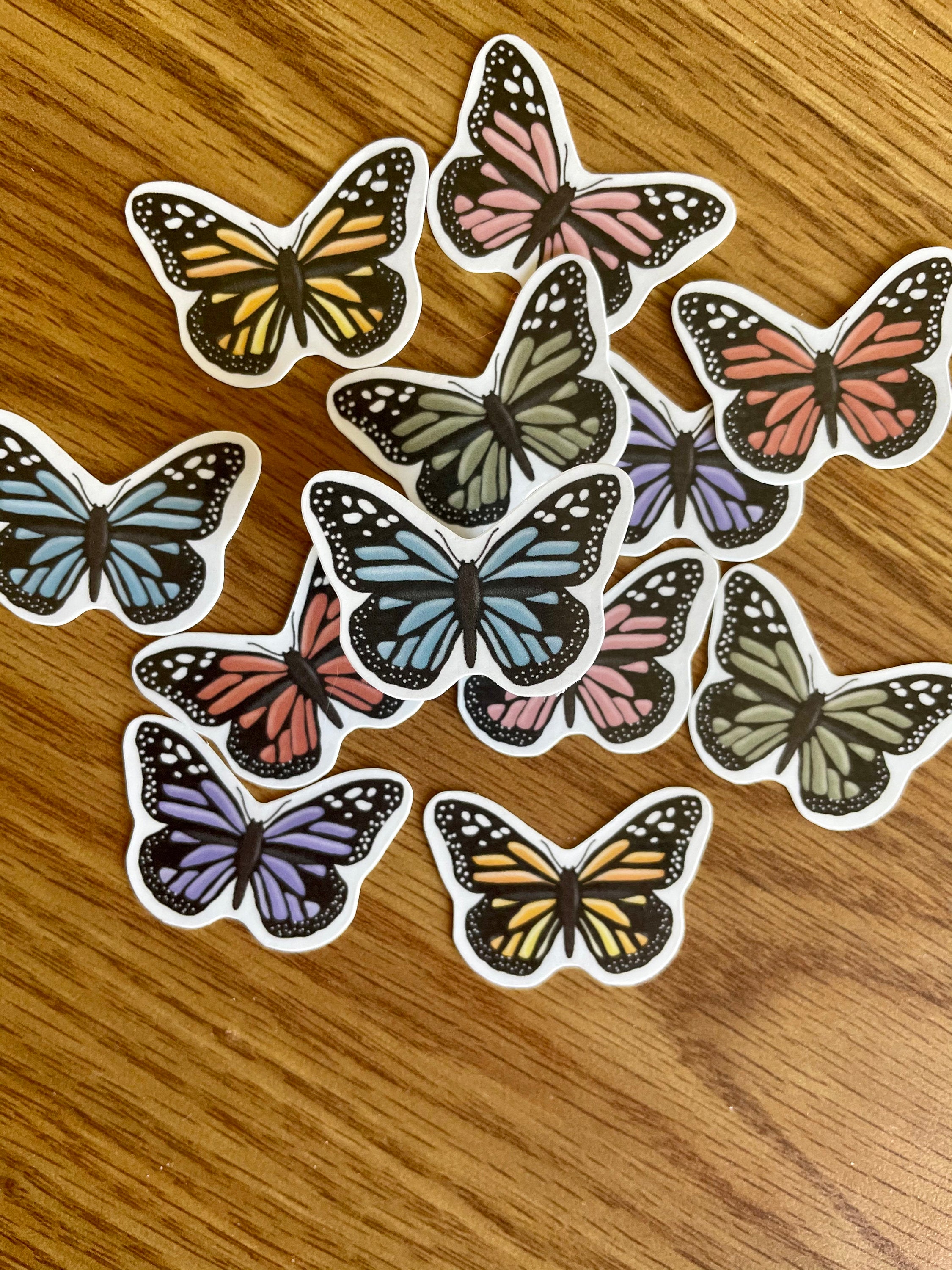 A colorful assortment of 12 mini butterfly stickers, showcasing vibrant designs perfect for personalizing items.