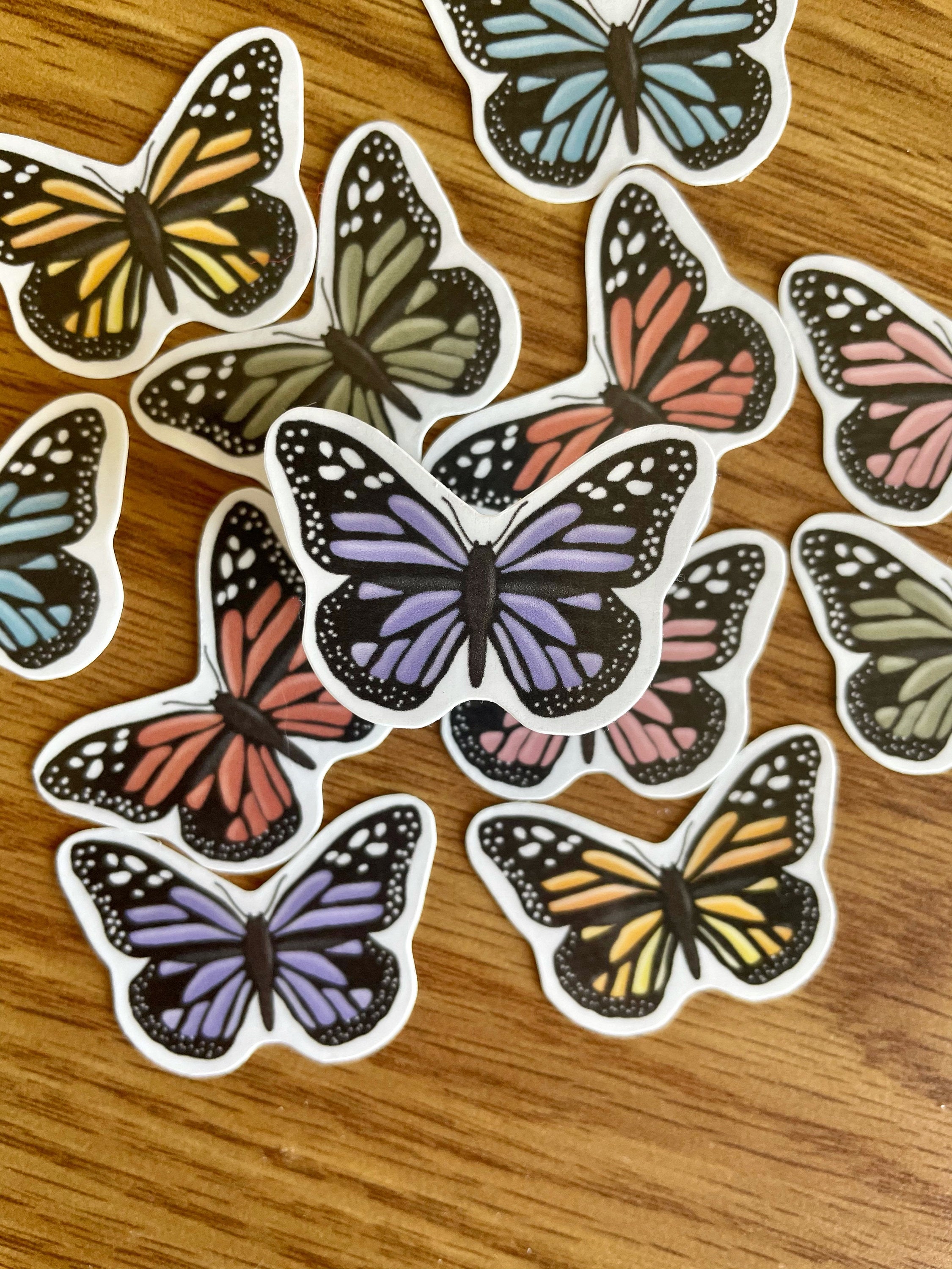 A colorful assortment of 12 mini butterfly stickers, showcasing vibrant designs perfect for personalizing items.