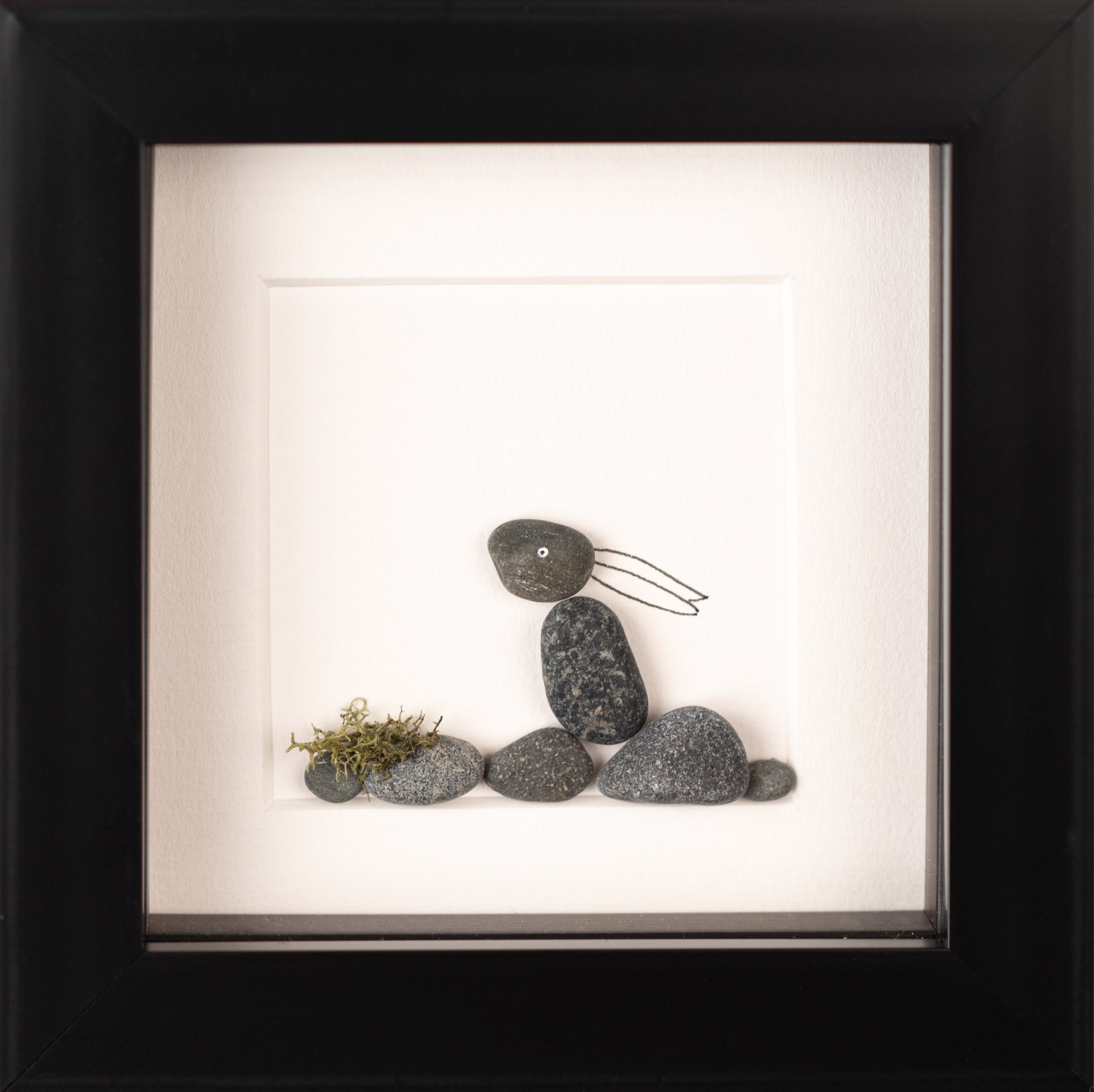 A beautifully crafted Mini Hare art piece framed in black, showcasing its unique design inspired by nature.