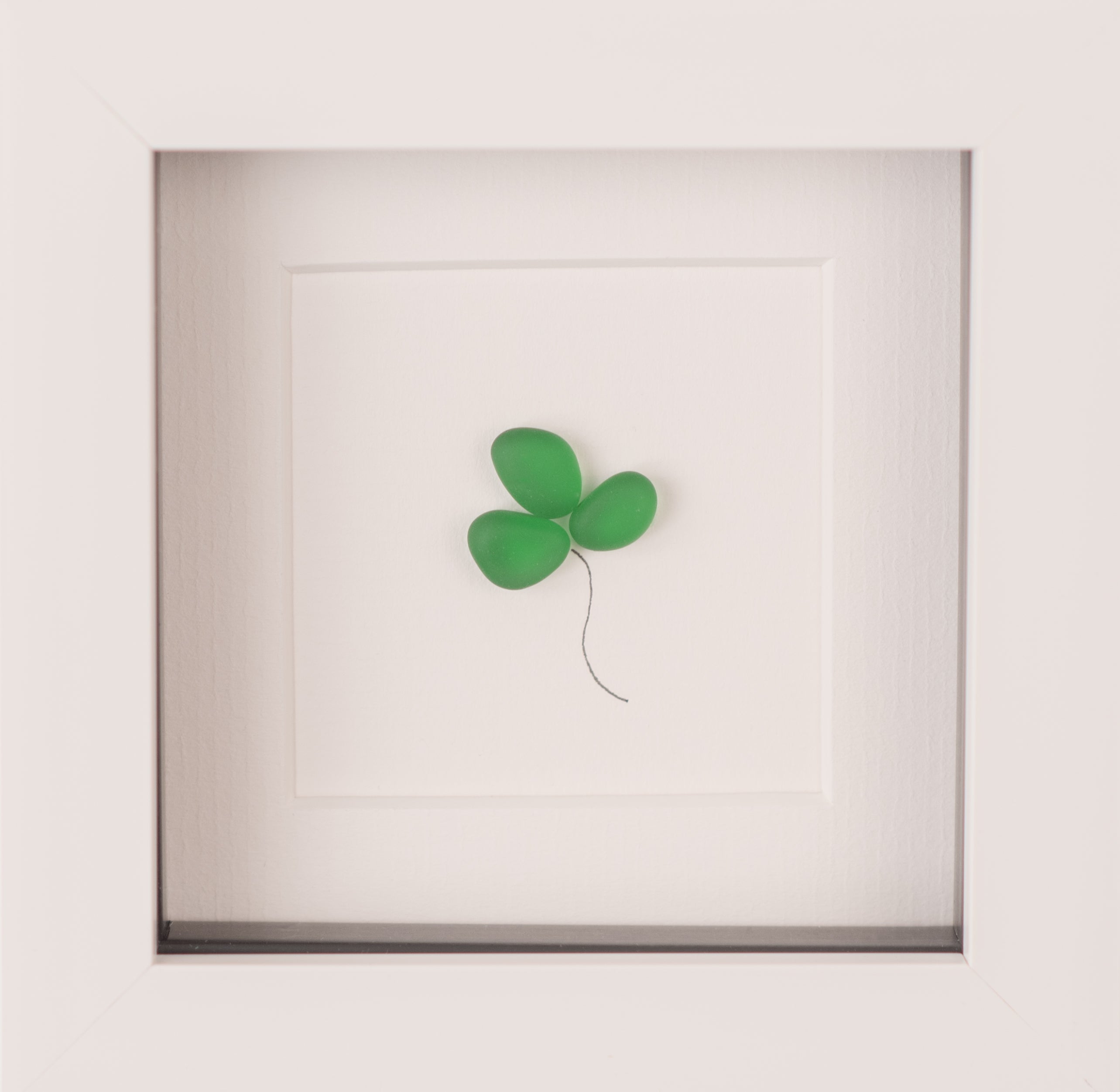 Mini Shamrock artwork made from tiny beach pebbles, framed in black or white, symbolizing Irish culture.