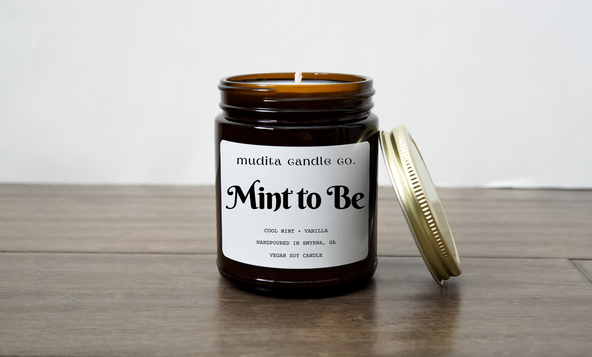 Mint to Be candle in amber glass jar with gold lid, featuring a refreshing Cool Mint & Vanilla scent.