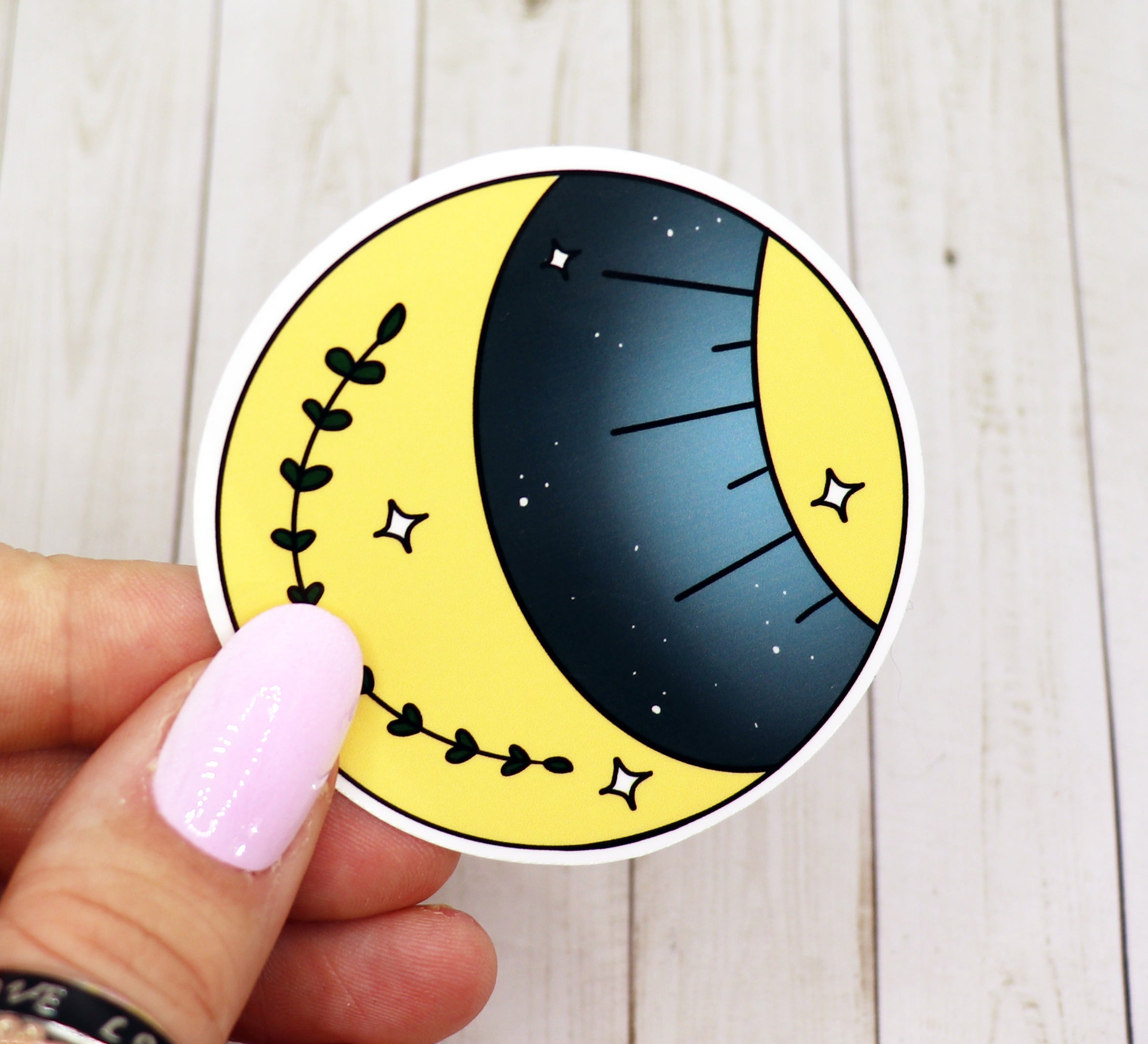 A vibrant Moon and Sun Vinyl Sticker featuring celestial designs, perfect for personalizing various items.