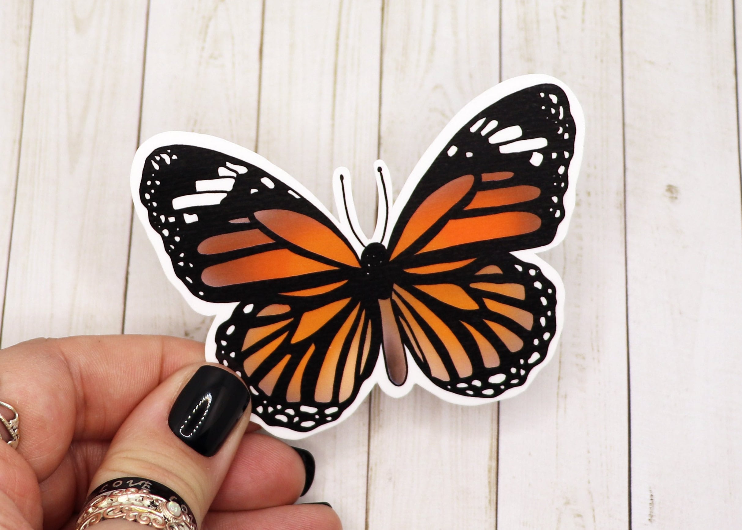 A vibrant Monarch Butterfly Sticker on a white background, showcasing intricate details and colors.