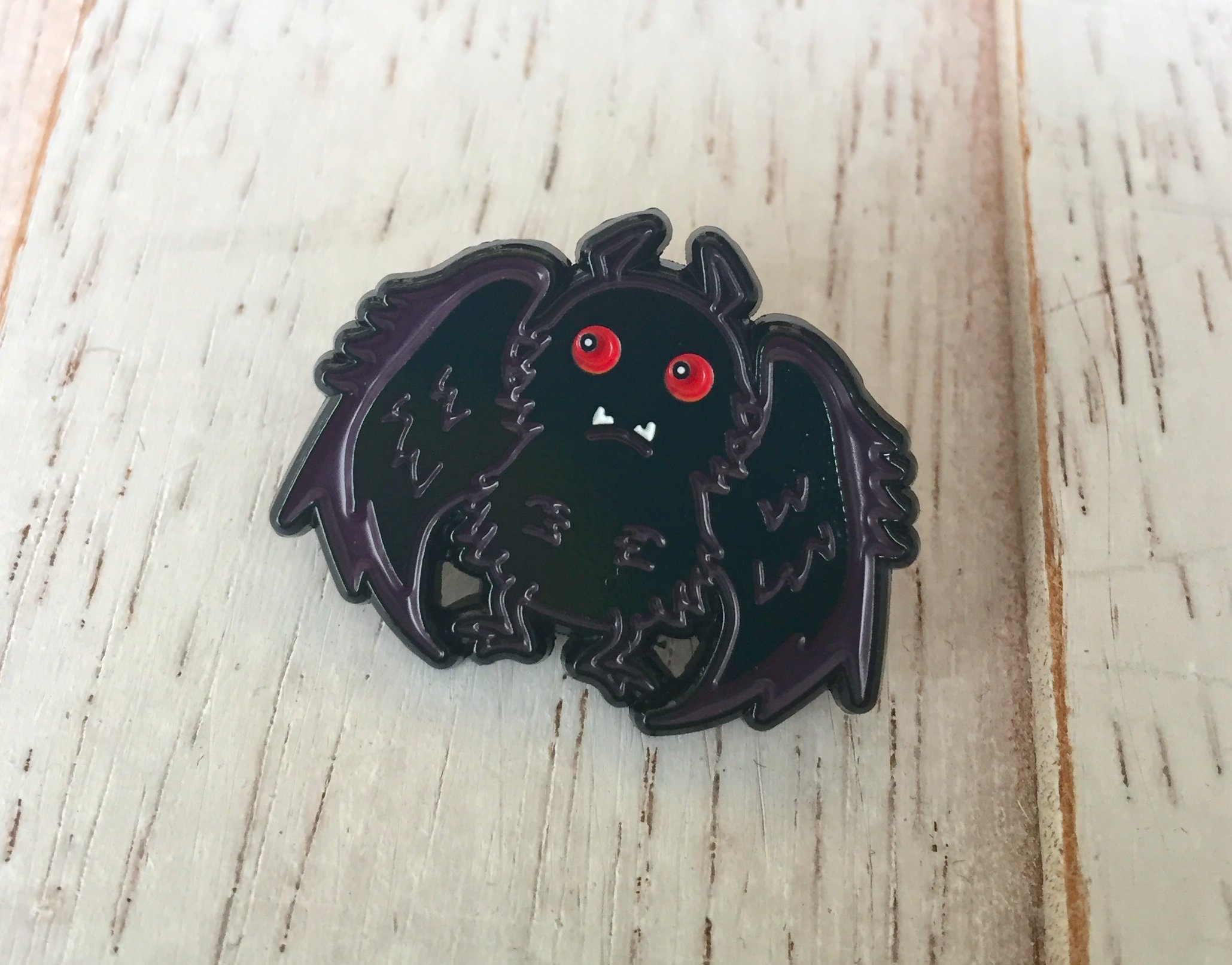 Mothman Soft Enamel Pin featuring intricate design, 1 inch in size, with a rubber pin back.