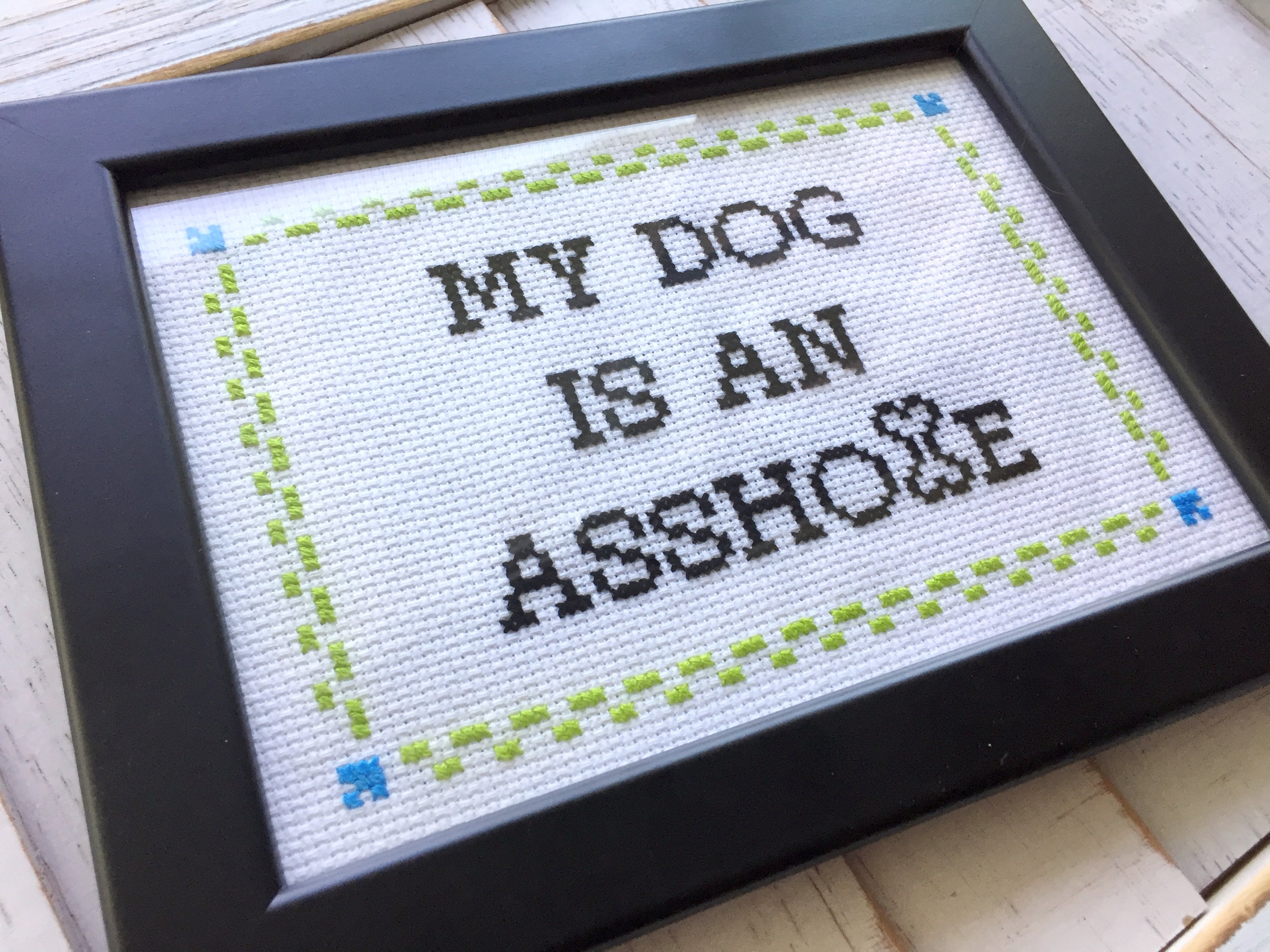 My DOG is an A**hole Cross Stitch DIY Kit featuring a humorous design for dog lovers, including all necessary materials for crafting.