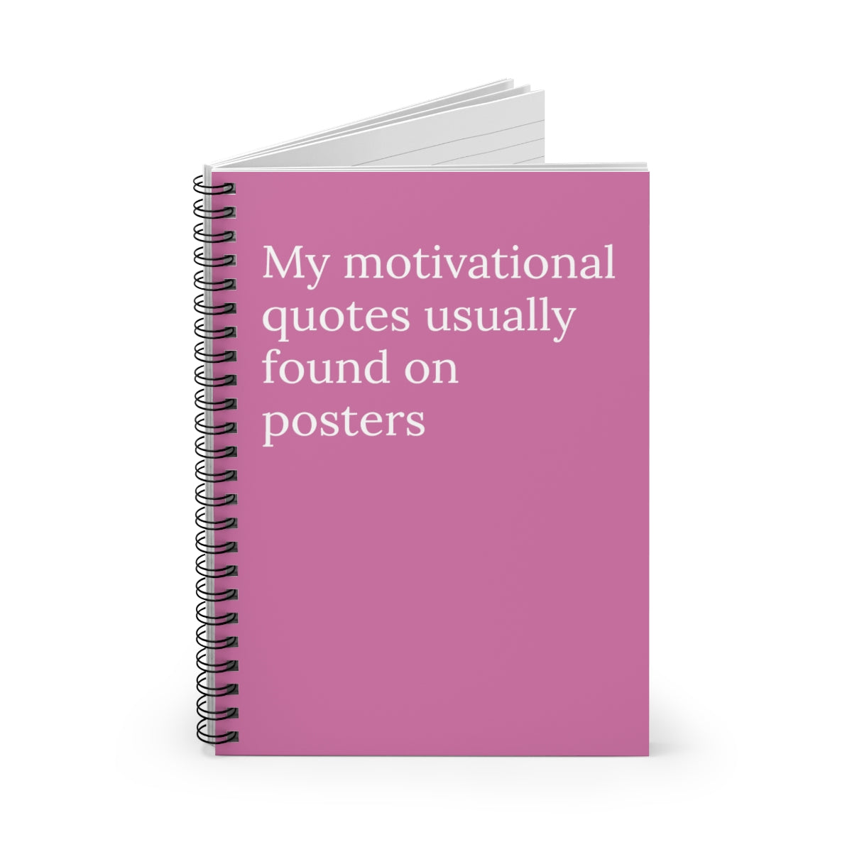 A spiral-bound notebook with humorous motivational quotes on the cover, featuring ruled line pages inside.