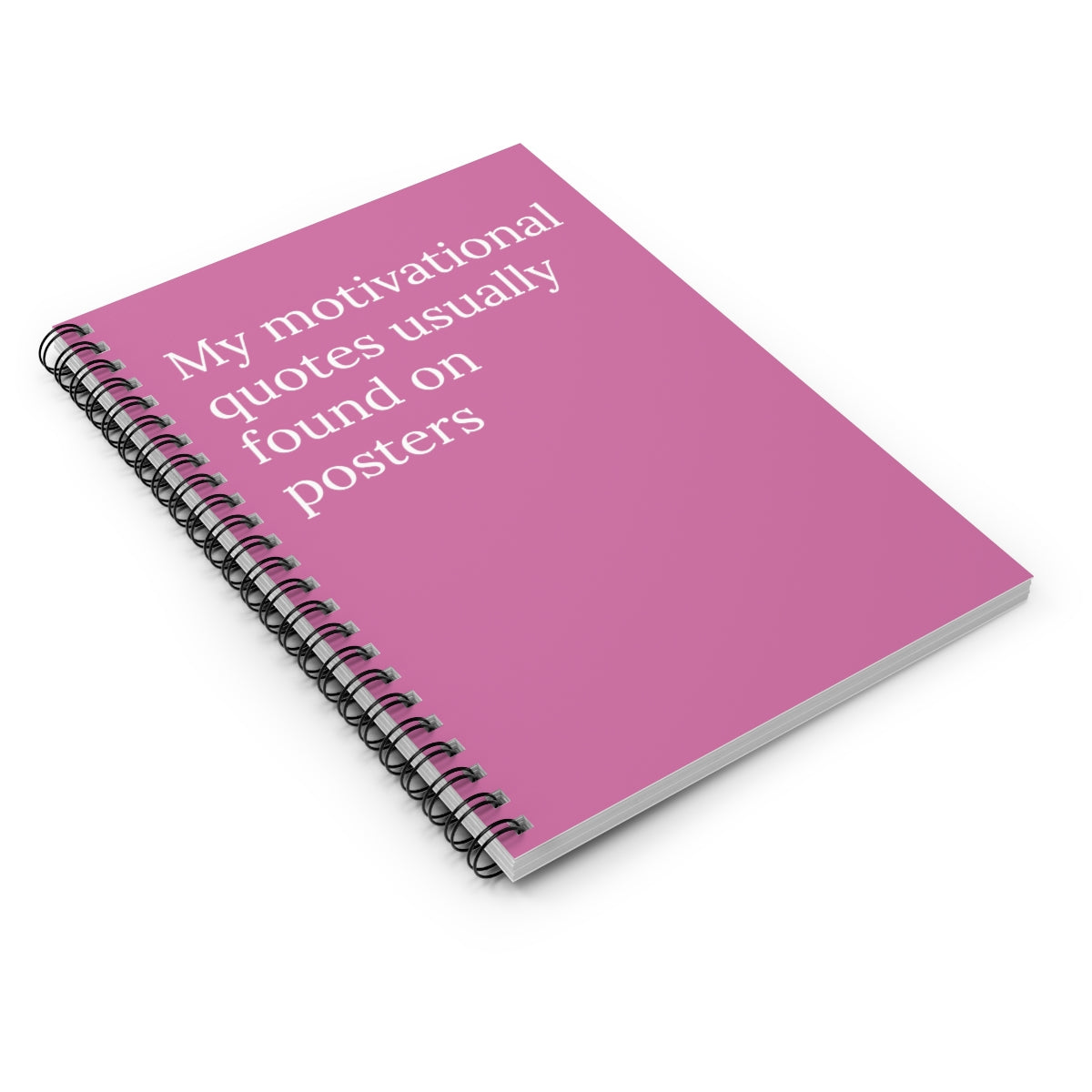 A spiral-bound notebook with humorous motivational quotes on the cover, featuring ruled line pages inside.