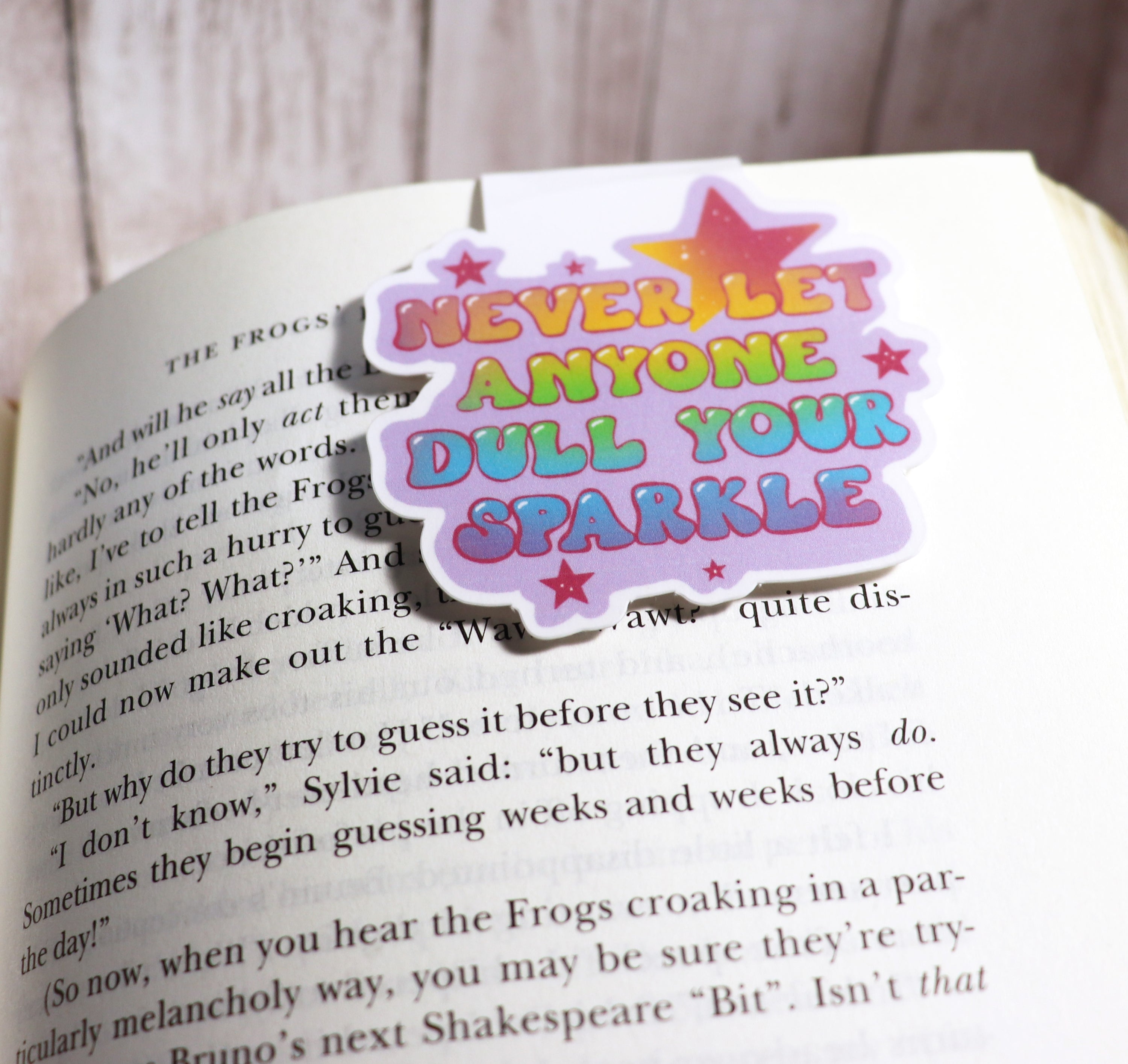 A colorful bookmark featuring the phrase 'Never Let Anyone Dull Your Sparkle', designed with strong magnets and a durable finish.