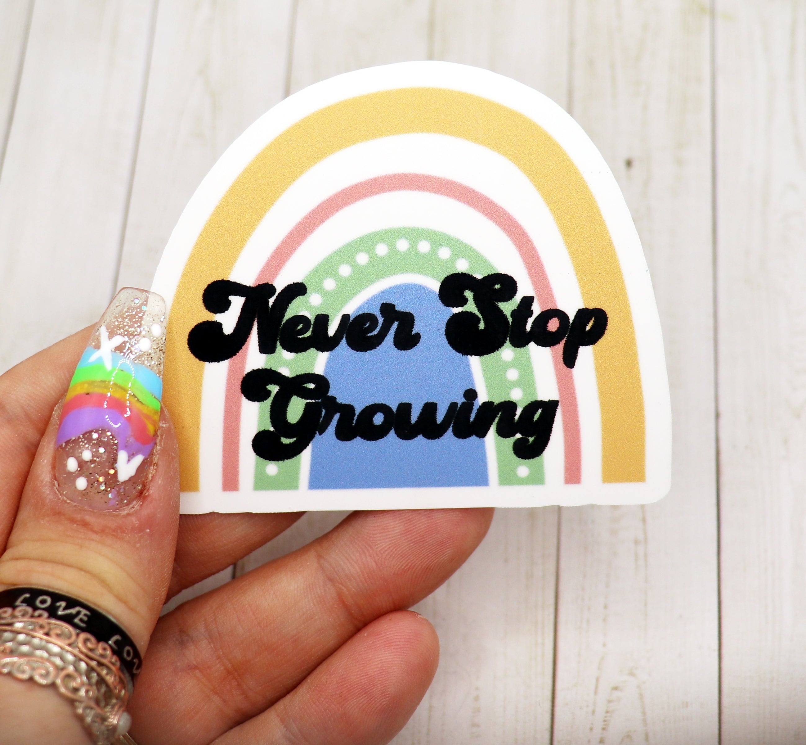 Never Stop Growing Vinyl Sticker featuring a motivational design on matte vinyl, perfect for personalizing various items.