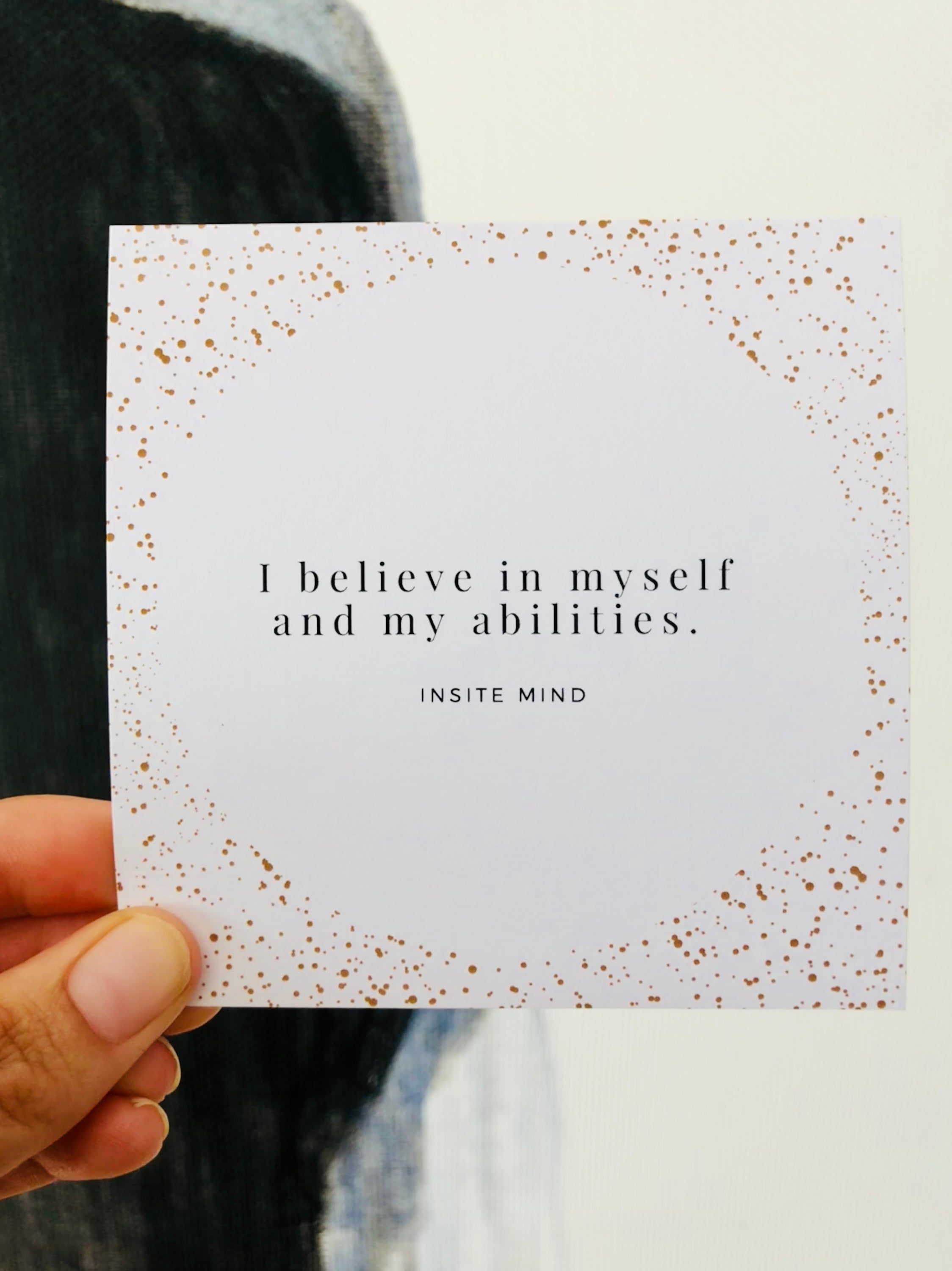 A beautifully designed set of Oh Happy Life affirmation cards displayed with a stylish card stand, featuring positive messages for daily inspiration.