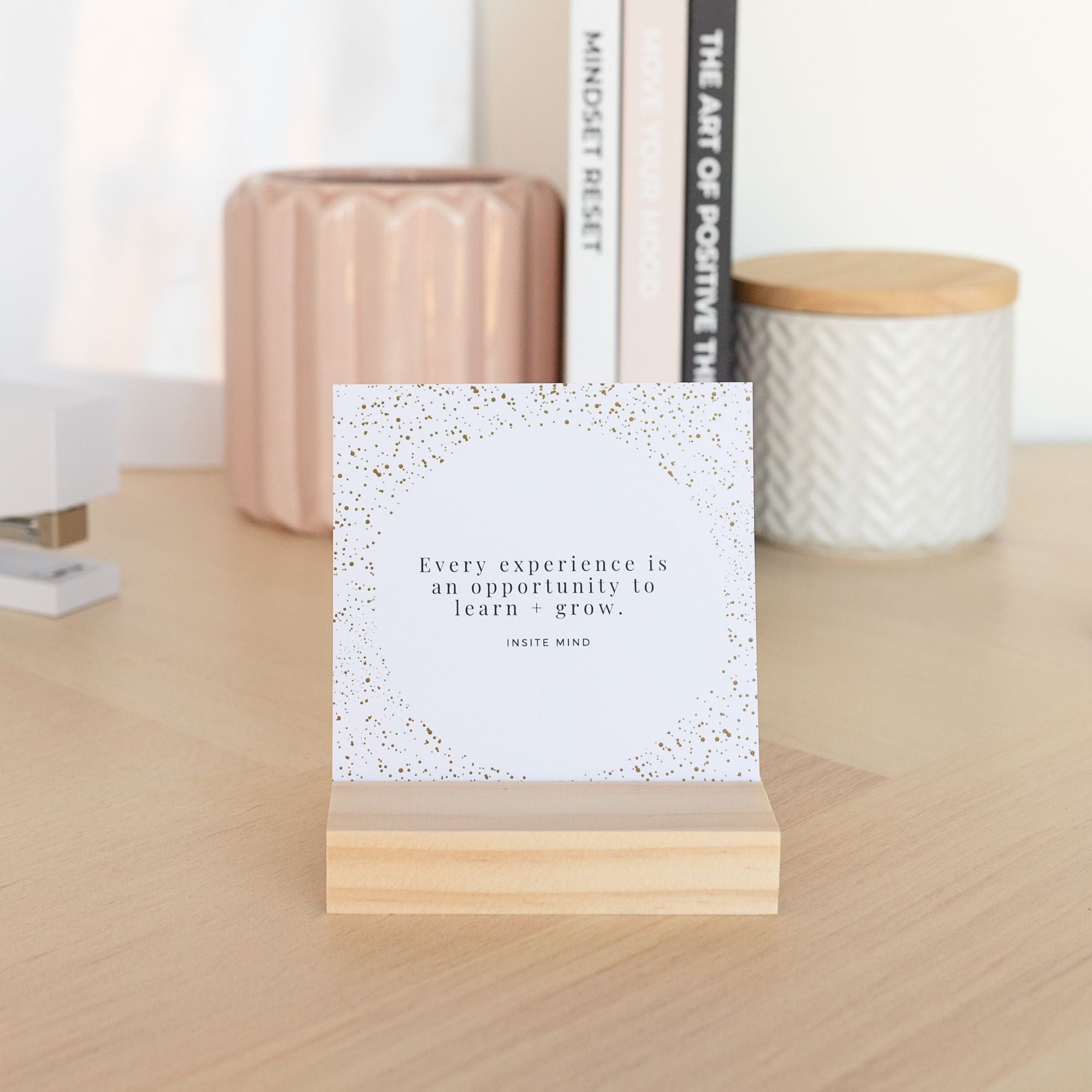 A beautifully designed set of Oh Happy Life affirmation cards displayed with a stylish card stand, featuring positive messages for daily inspiration.