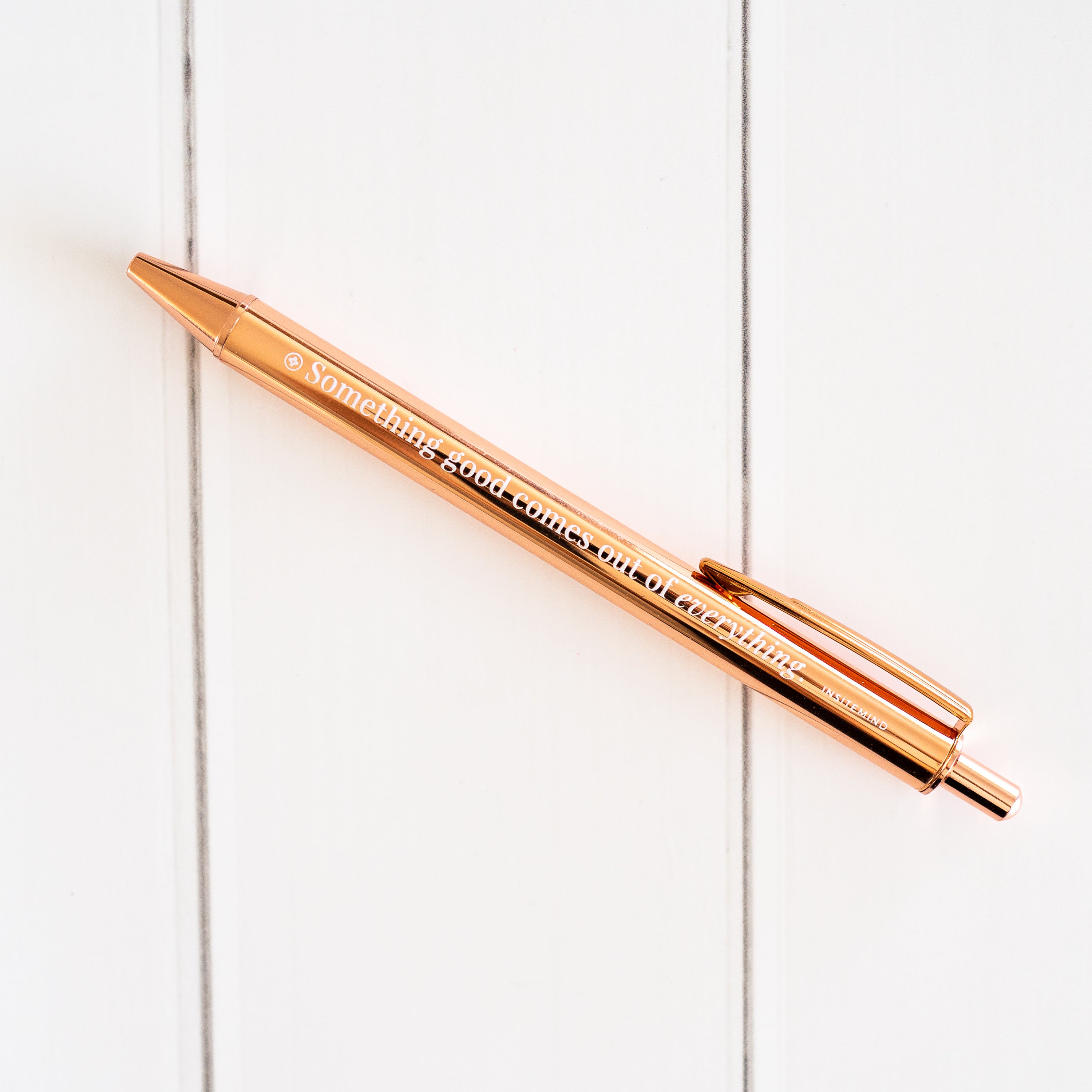 A stylish rose gold pen with a smooth finish, featuring an uplifting affirmation for positive writing.