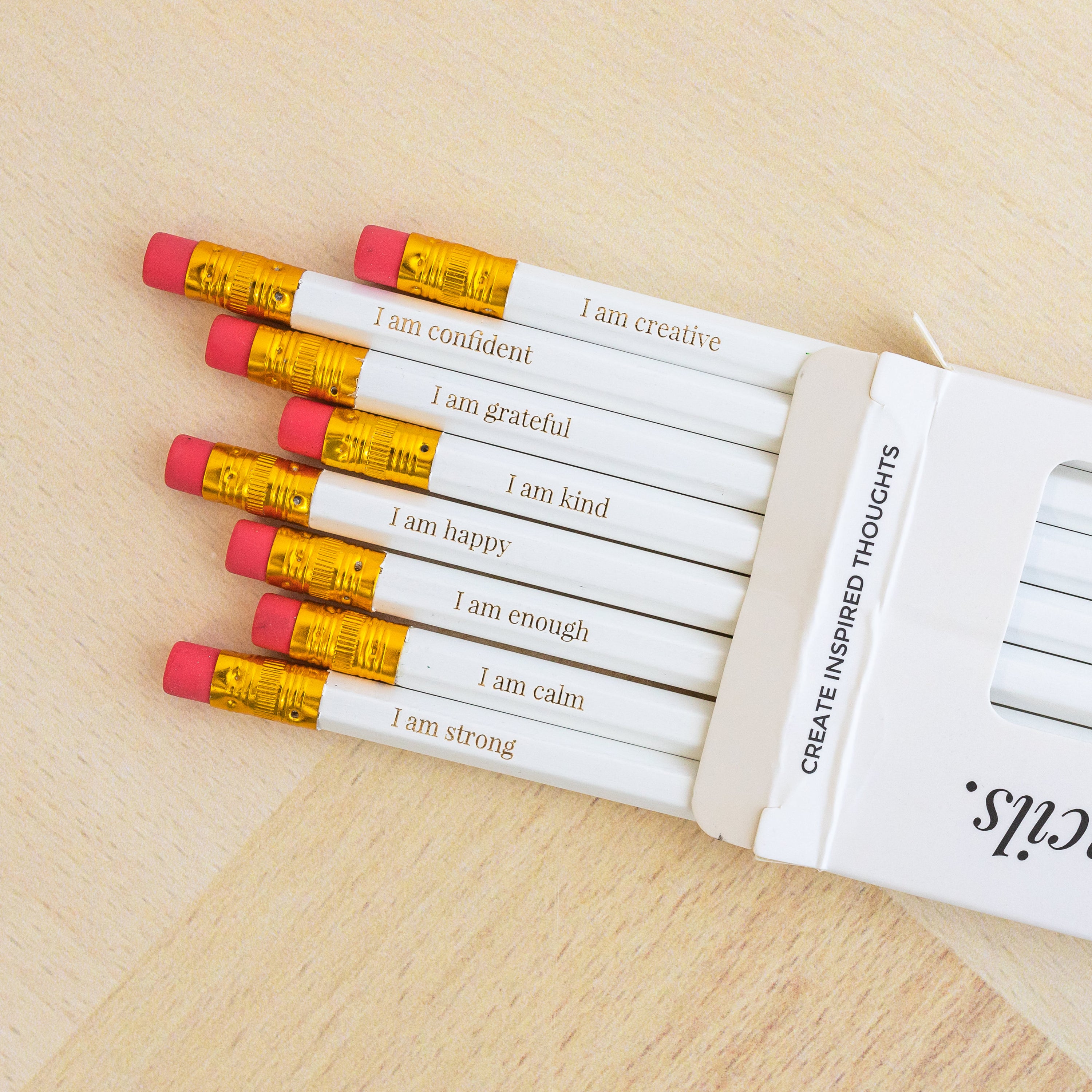 A colorful set of 8 HB affirmation pencils with positive messages like 'I am strong' and 'I am creative', perfect for inspiring writing.