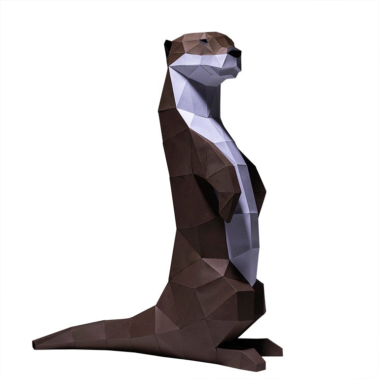 A charming self-standing otter figurine made from 3D kirigami paper, showcasing its playful design and intricate details.