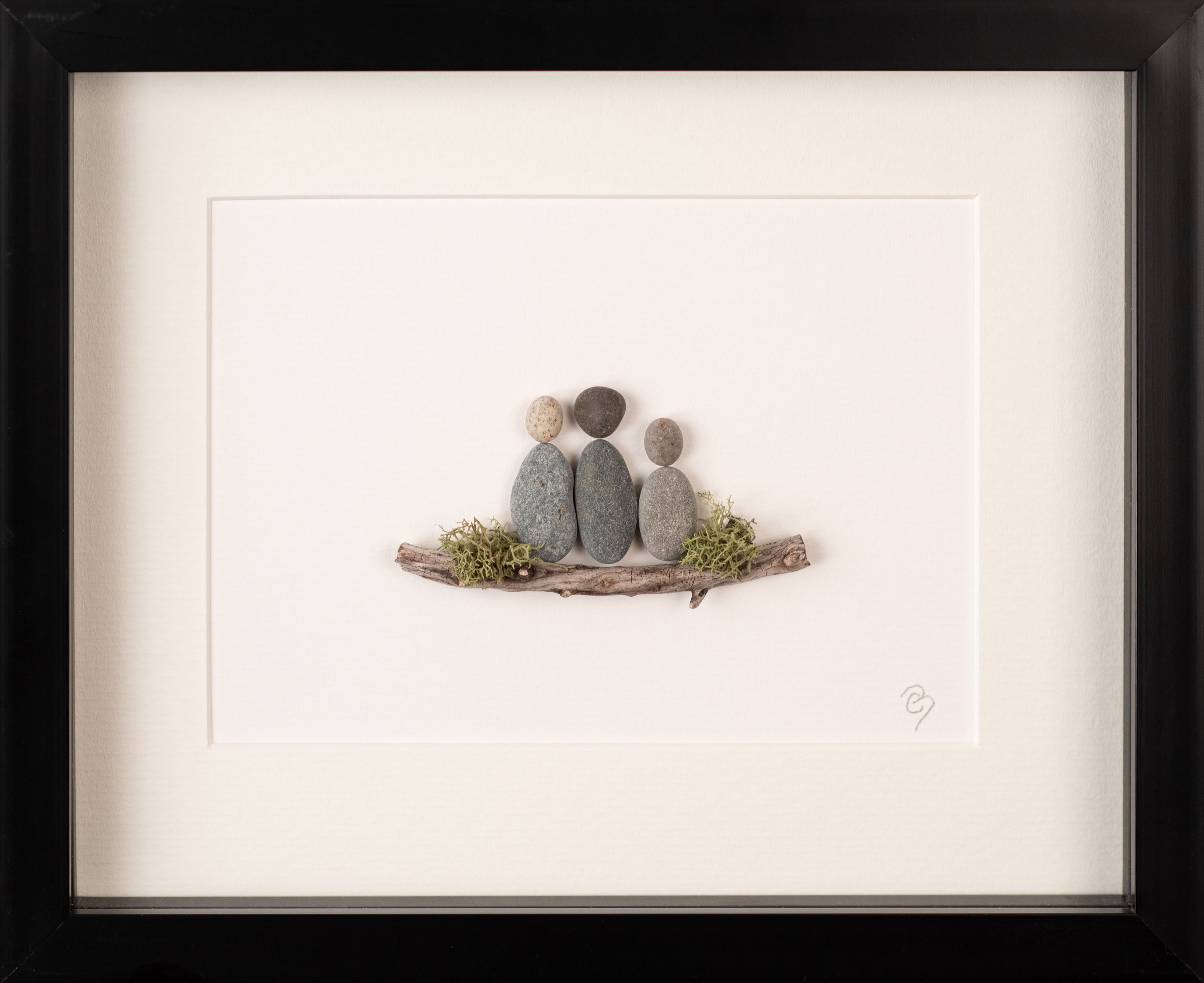 A beautifully framed artwork representing a family of four, showcasing unique, nature-inspired designs in a white or black frame.