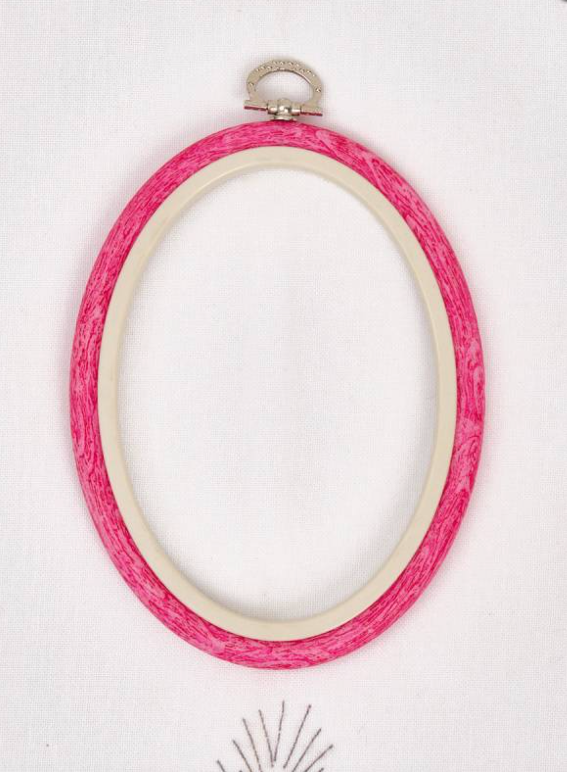 Nurge 230-7 Pink Flexi Hoop, oval embroidery tool with rubberized outer and decorative hook for hanging.