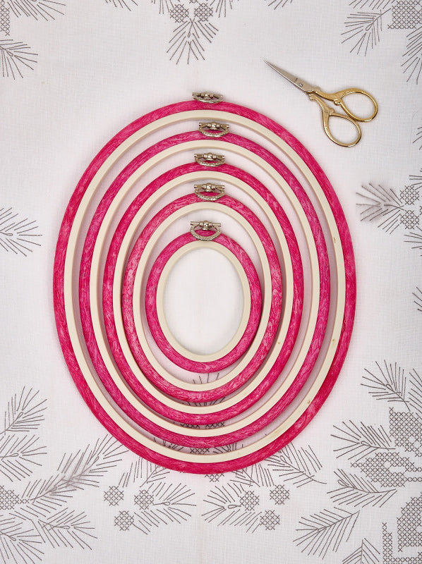 Nurge 230-7 Pink Flexi Hoop, oval embroidery tool with rubberized outer and decorative hook for hanging.