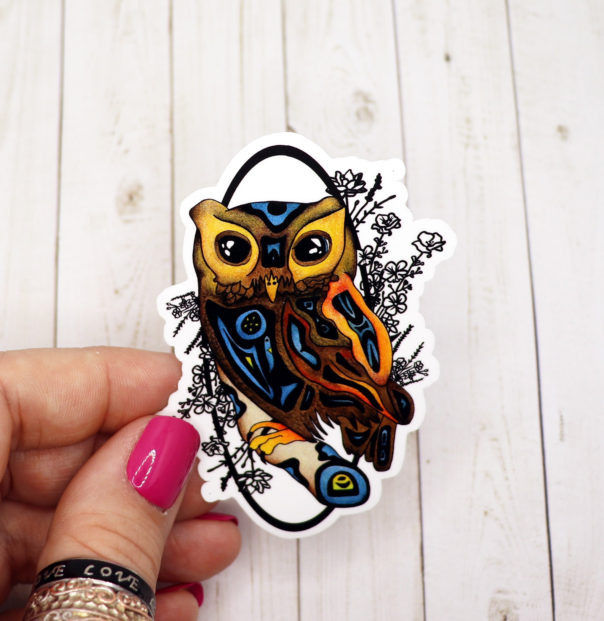 A colorful owl sticker on a matte vinyl background, showcasing its intricate design and vibrant colors.