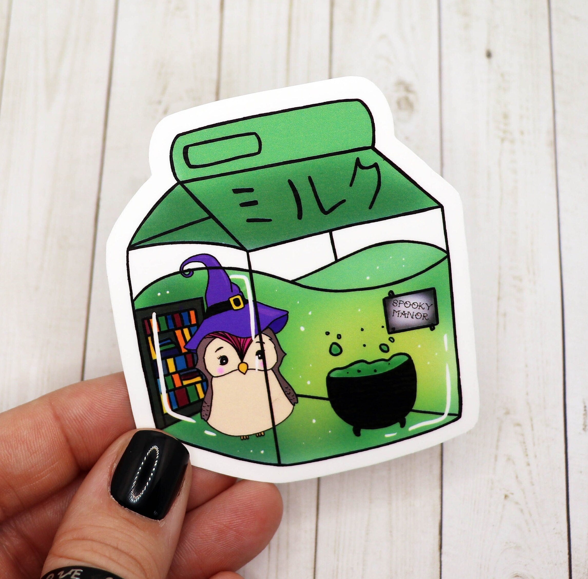 A whimsical sticker featuring an owl dressed as a witch inside a milk carton, printed on high-quality matte vinyl.