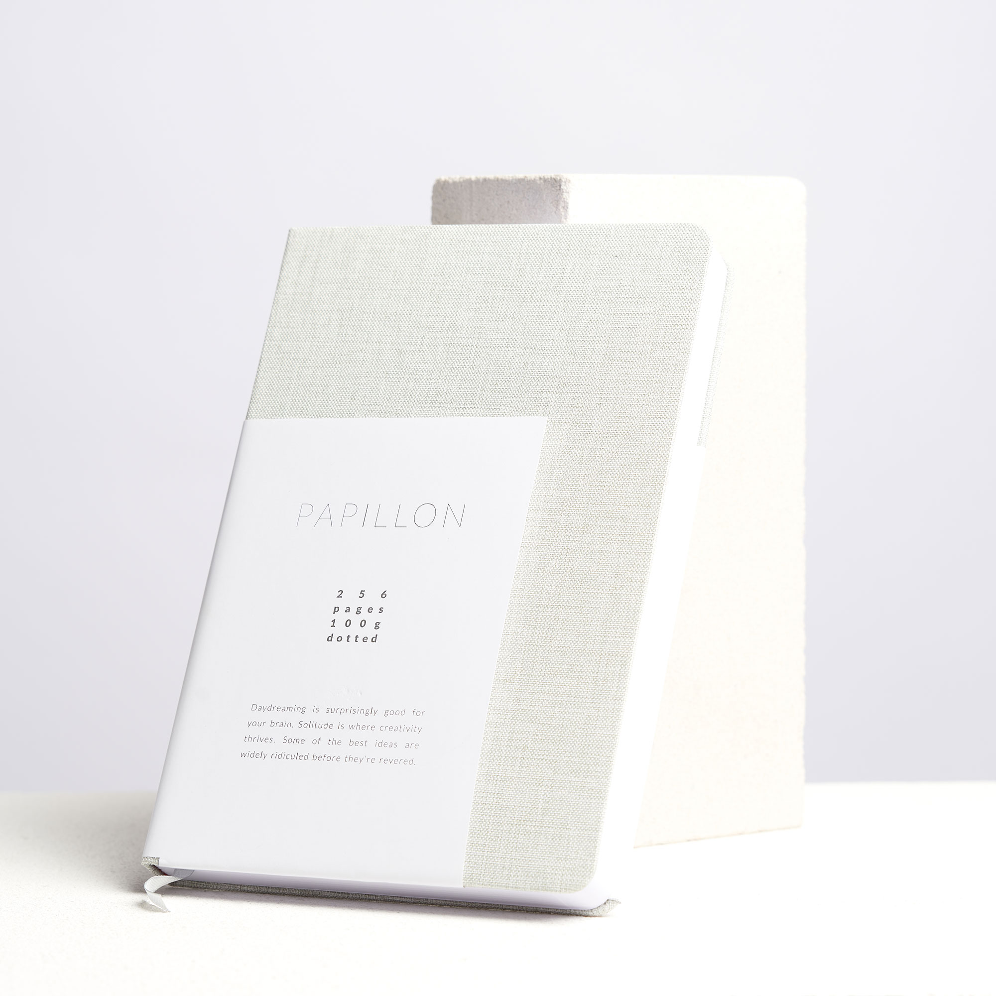 Grey hardcover notebook with label.