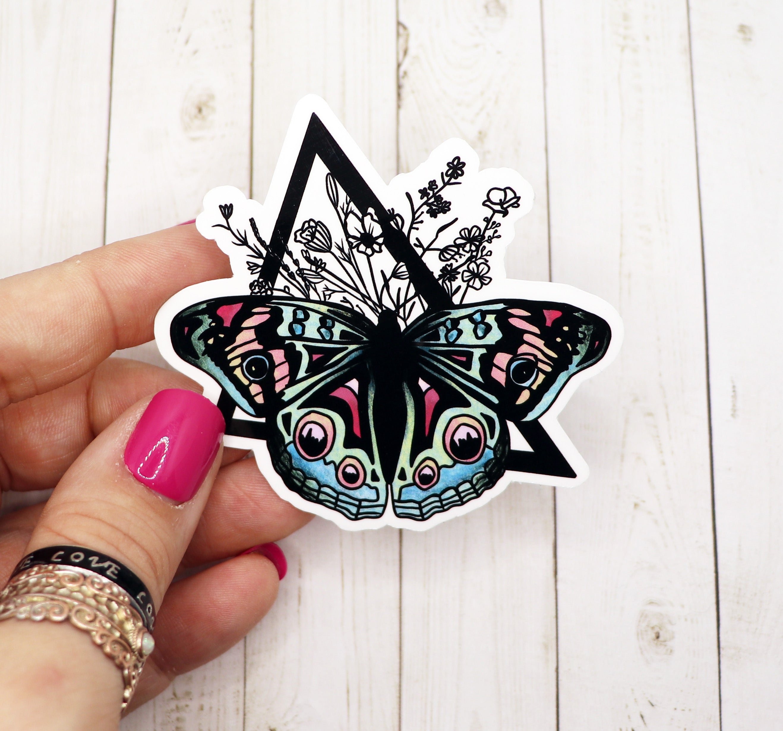 A vibrant pastel butterfly sticker on a white background, showcasing its intricate design and matte finish.