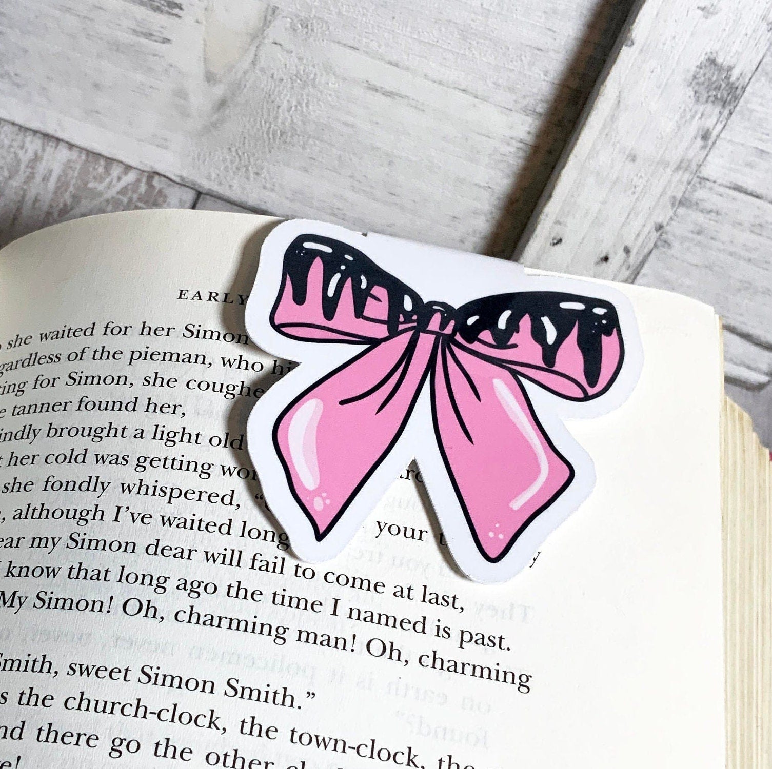 Pastel pink goth bow magnetic bookmark featuring a stylish design with strong magnets for secure page holding.