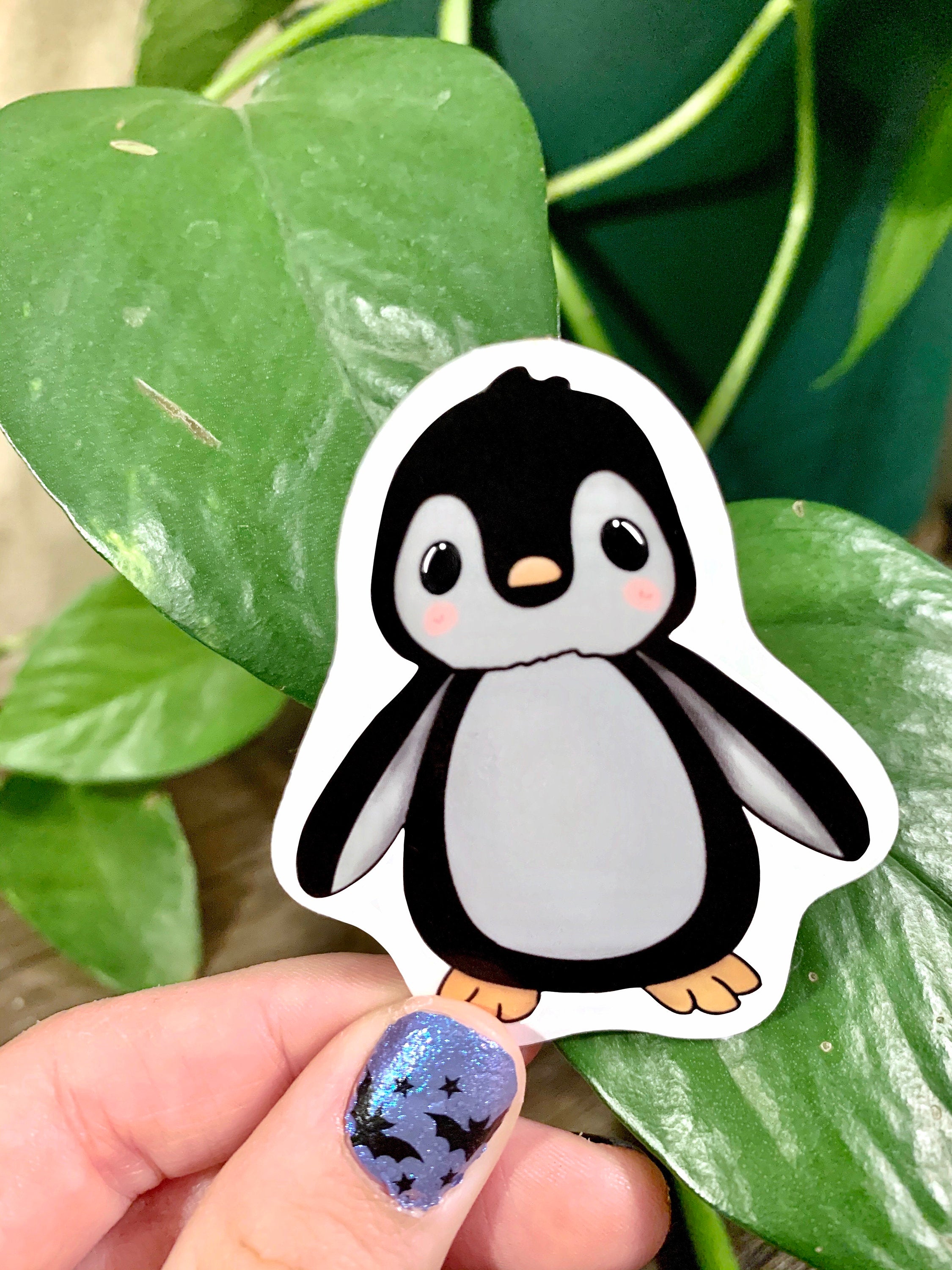 A cute penguin sticker designed for customization, featuring a vibrant penguin illustration on a waterproof background.