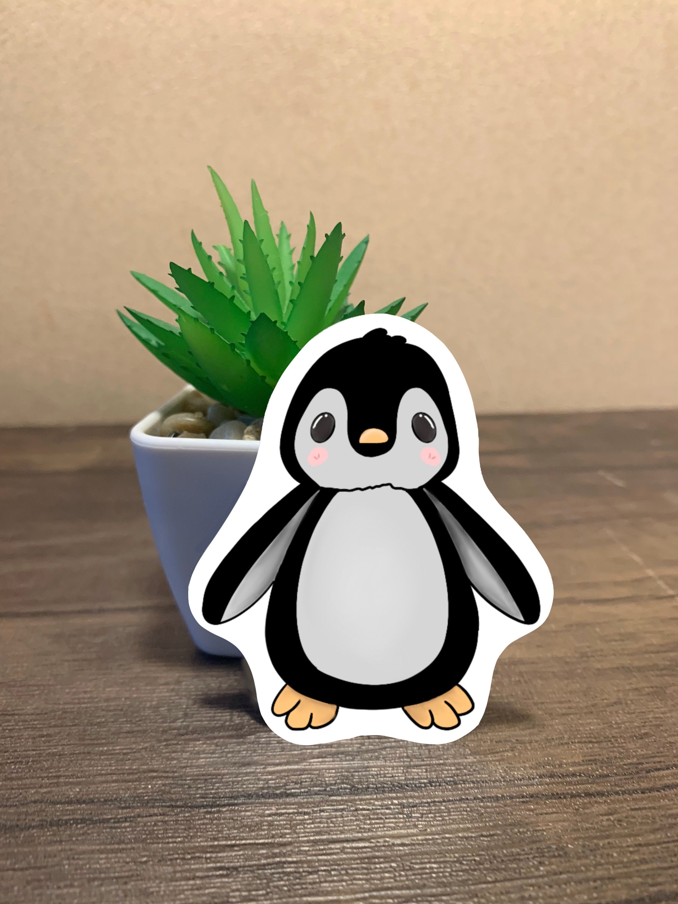 A cute penguin sticker designed for customization, featuring a vibrant penguin illustration on a waterproof background.