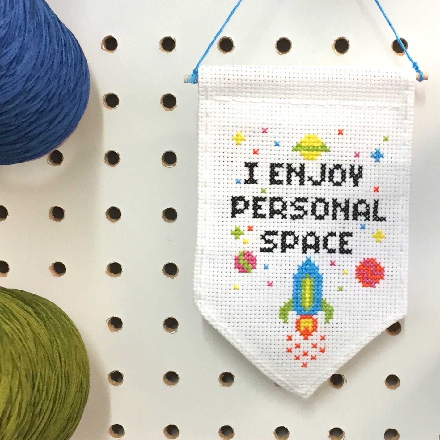 Personal Space Tiny Banner Counted Cross Stitch Kit featuring neon threads on white aida cloth, includes all necessary supplies.