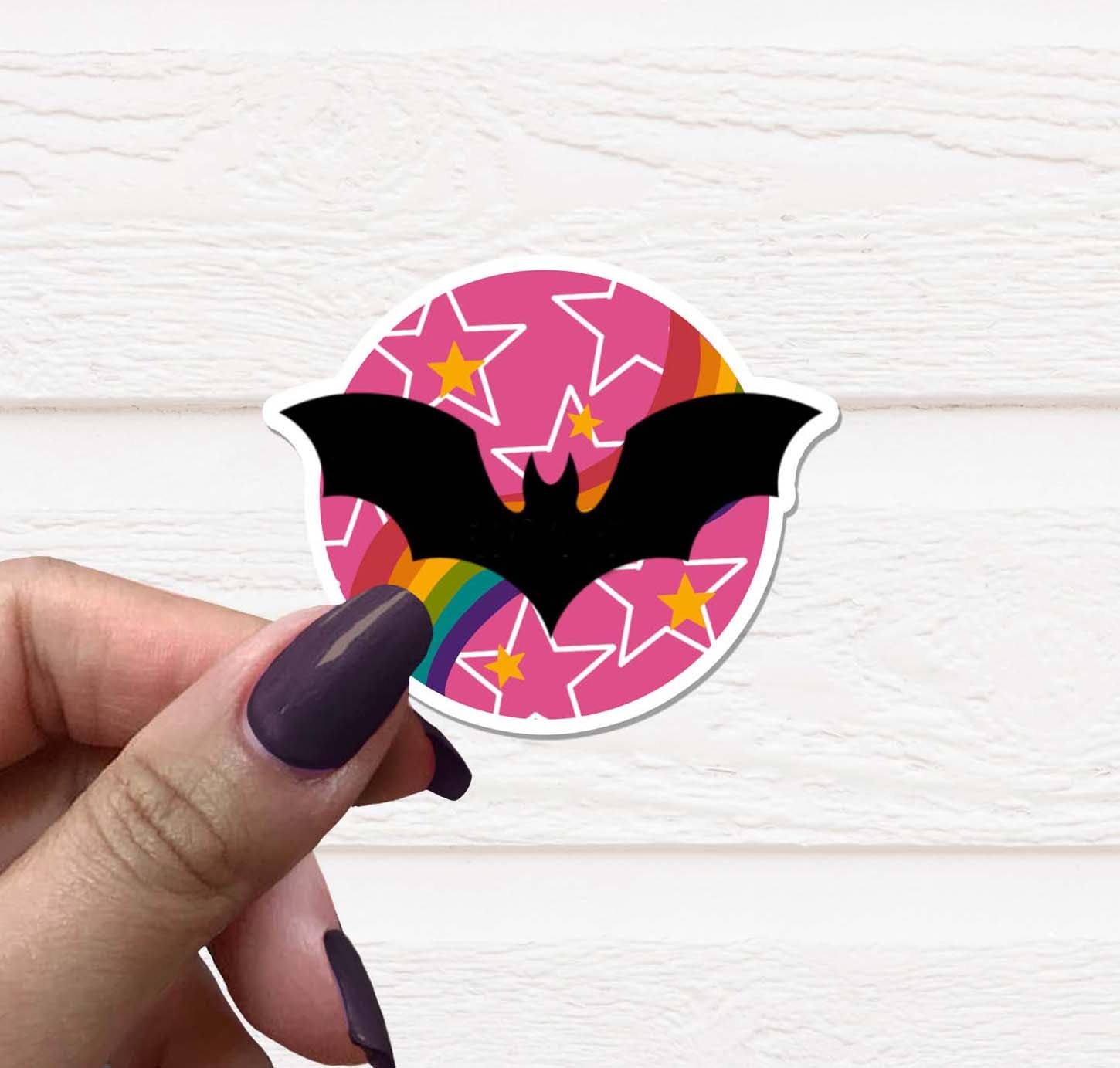 A vibrant pink bat vinyl sticker on a white background, showcasing its matte finish and detailed design.