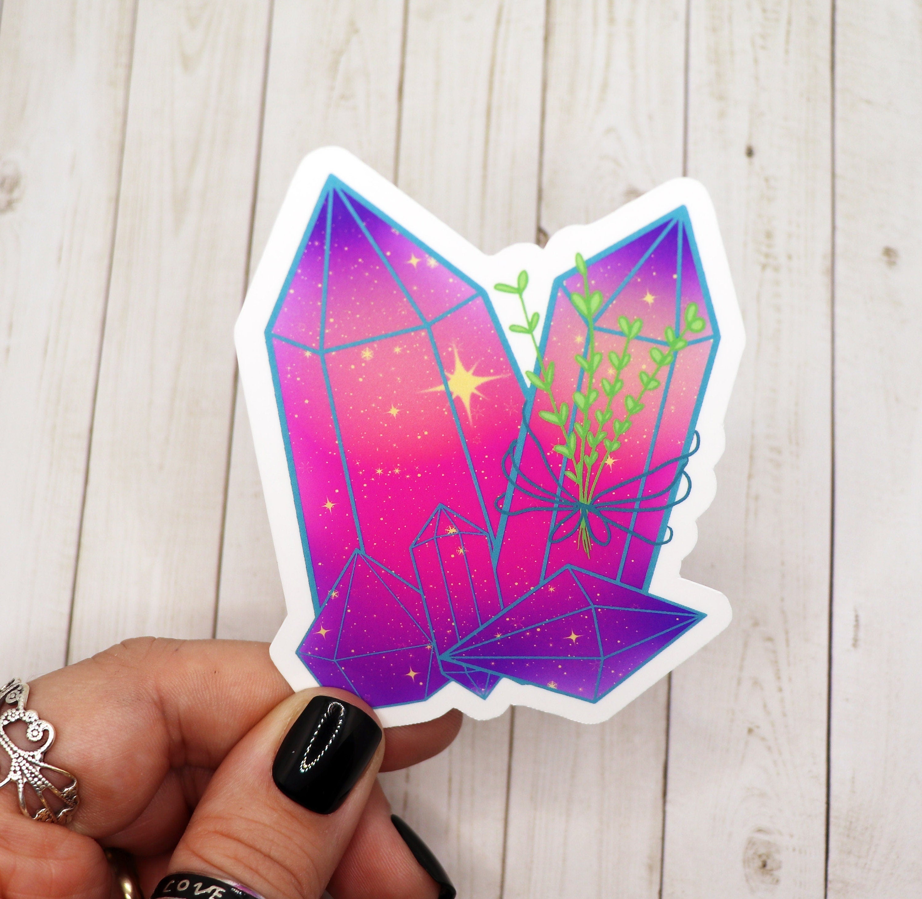 A vibrant pink celestial crystal sticker on a white background, showcasing its intricate design and matte finish.