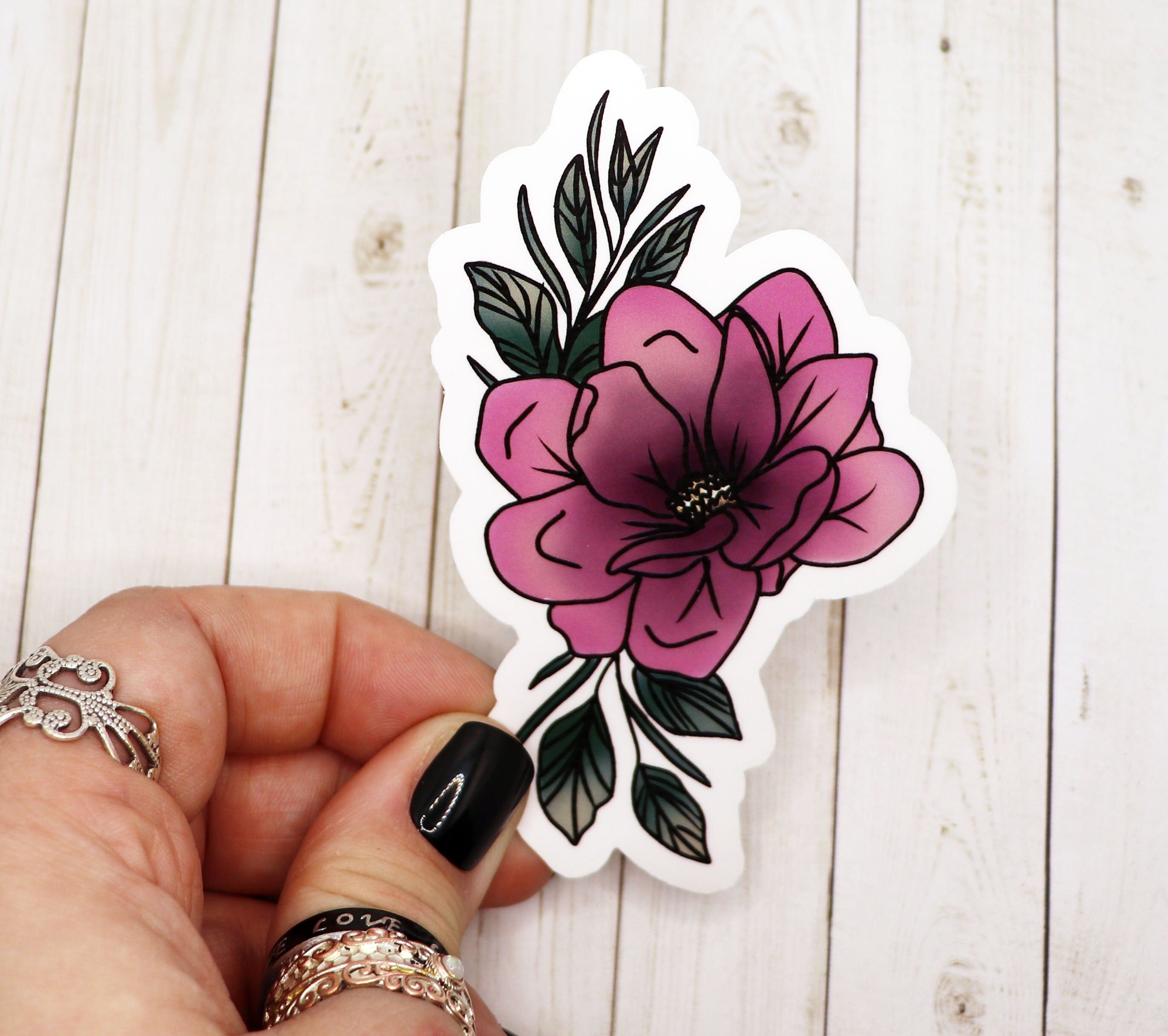 A vibrant pink flower sticker on a white background, showcasing its intricate design and matte finish.