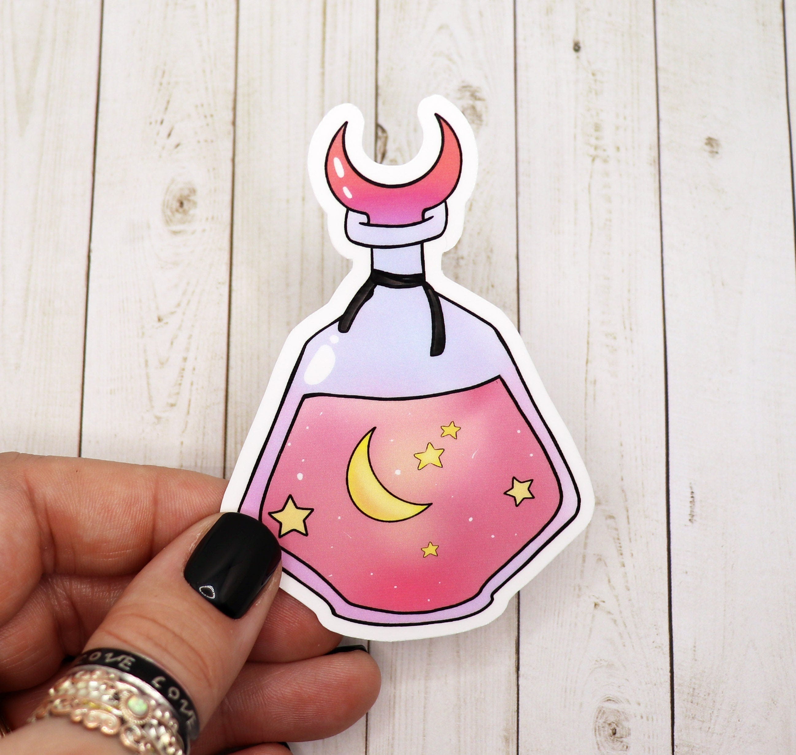 A vibrant Pink Moon and Stars Potion Bottle Sticker featuring a whimsical design with a potion bottle, pink moon, and stars, perfect for personalizing items.