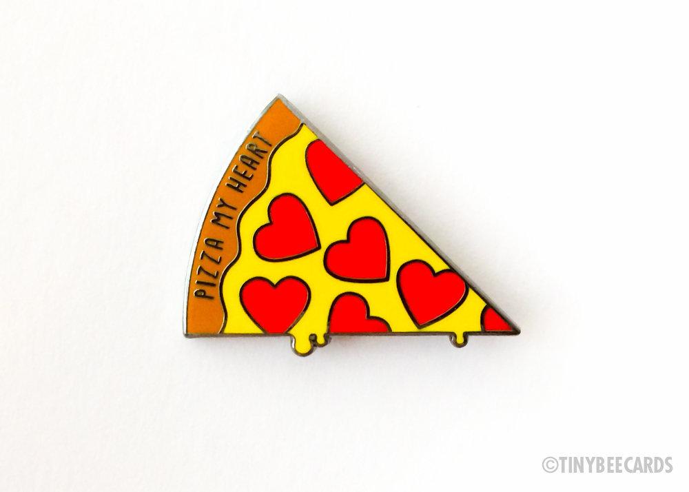 A colorful hard enamel pin featuring a pizza slice with heart-shaped pepperonis and the text 'Pizza My Heart'.