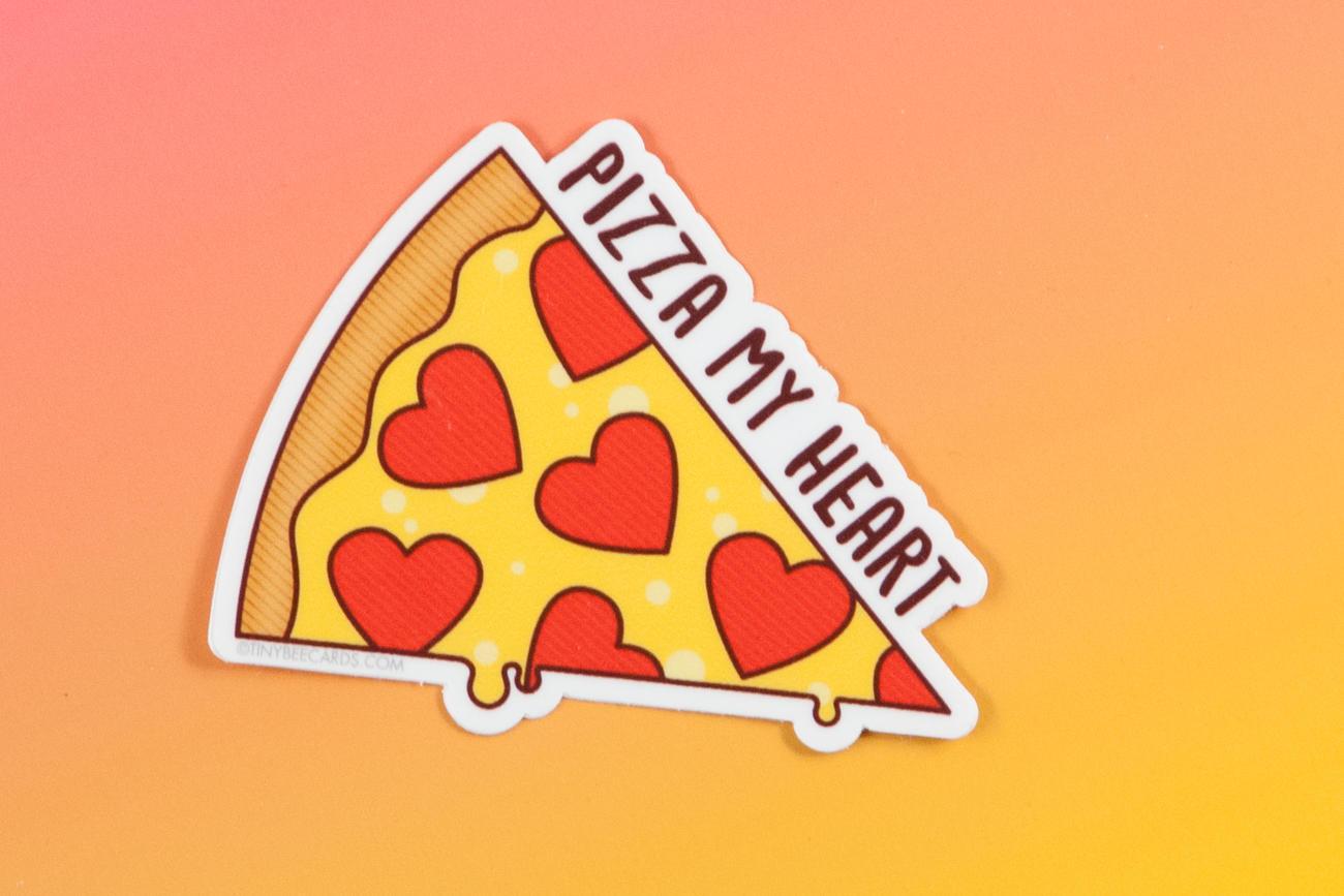 A colorful vinyl sticker featuring a pizza with heart-shaped pepperonis and the text 'Pizza My Heart!'