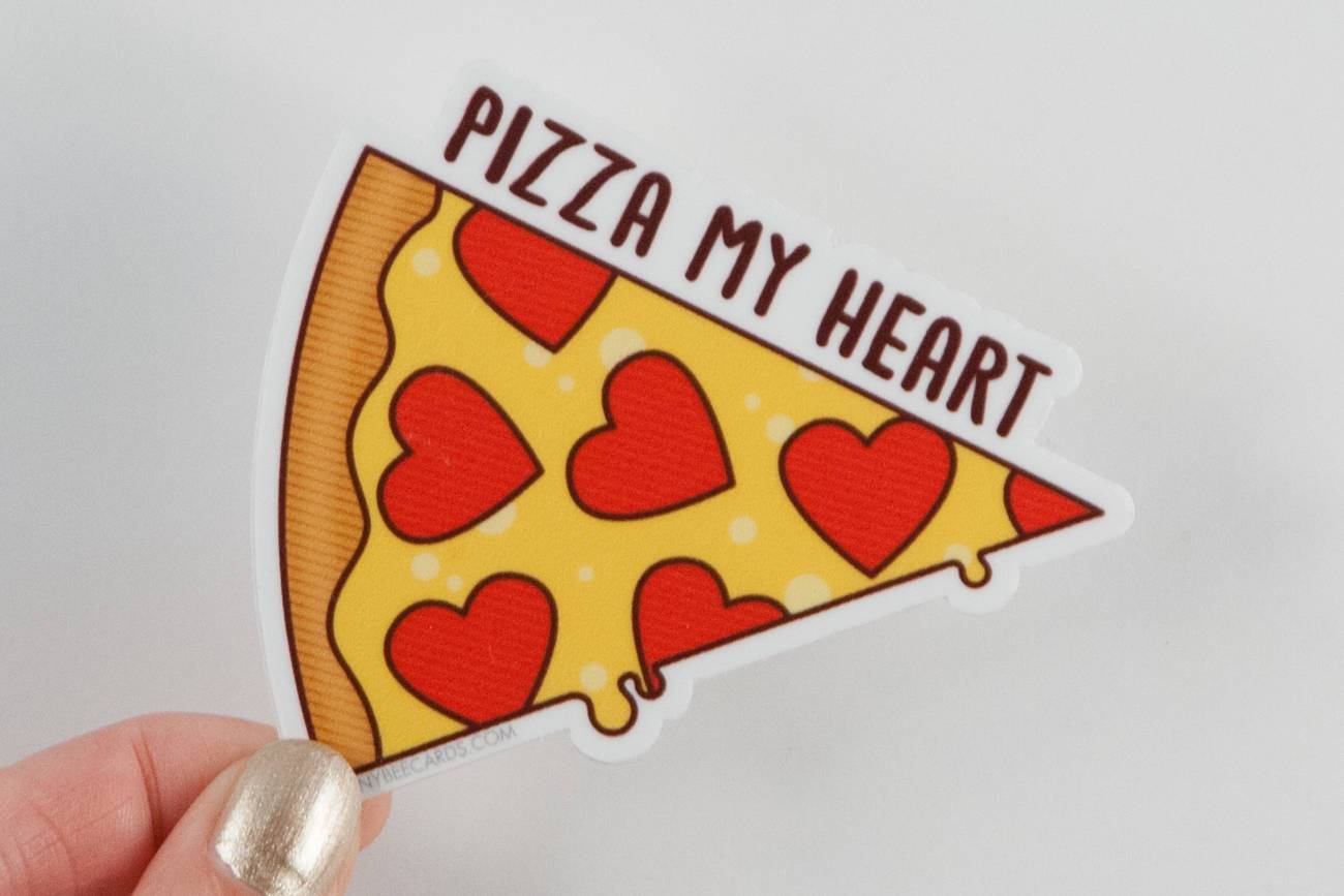 A colorful vinyl sticker featuring a pizza with heart-shaped pepperonis and the text 'Pizza My Heart!'