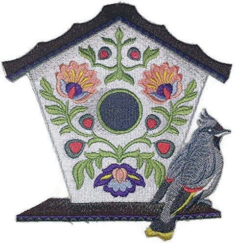 A beautifully crafted Polish Folk Art Birdhouse featuring an embroidered Bohemian Waxwing design, perfect for garden decoration.