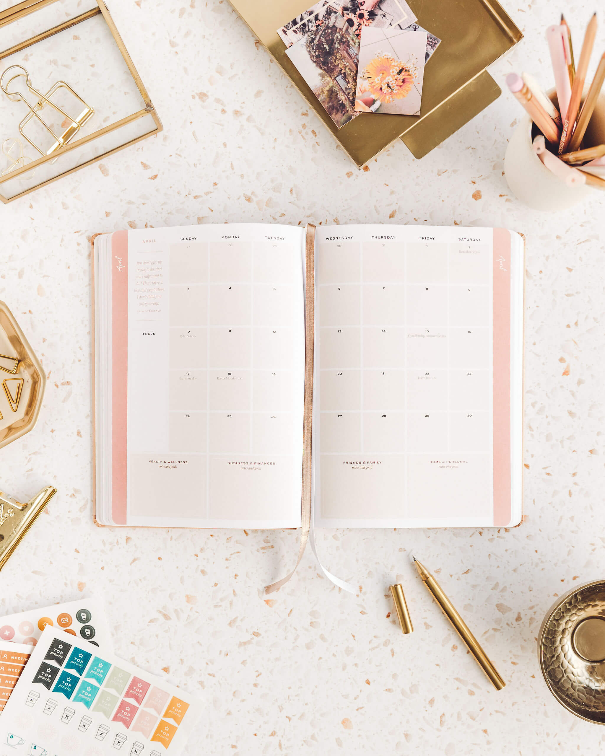 Open planner on marble desk.