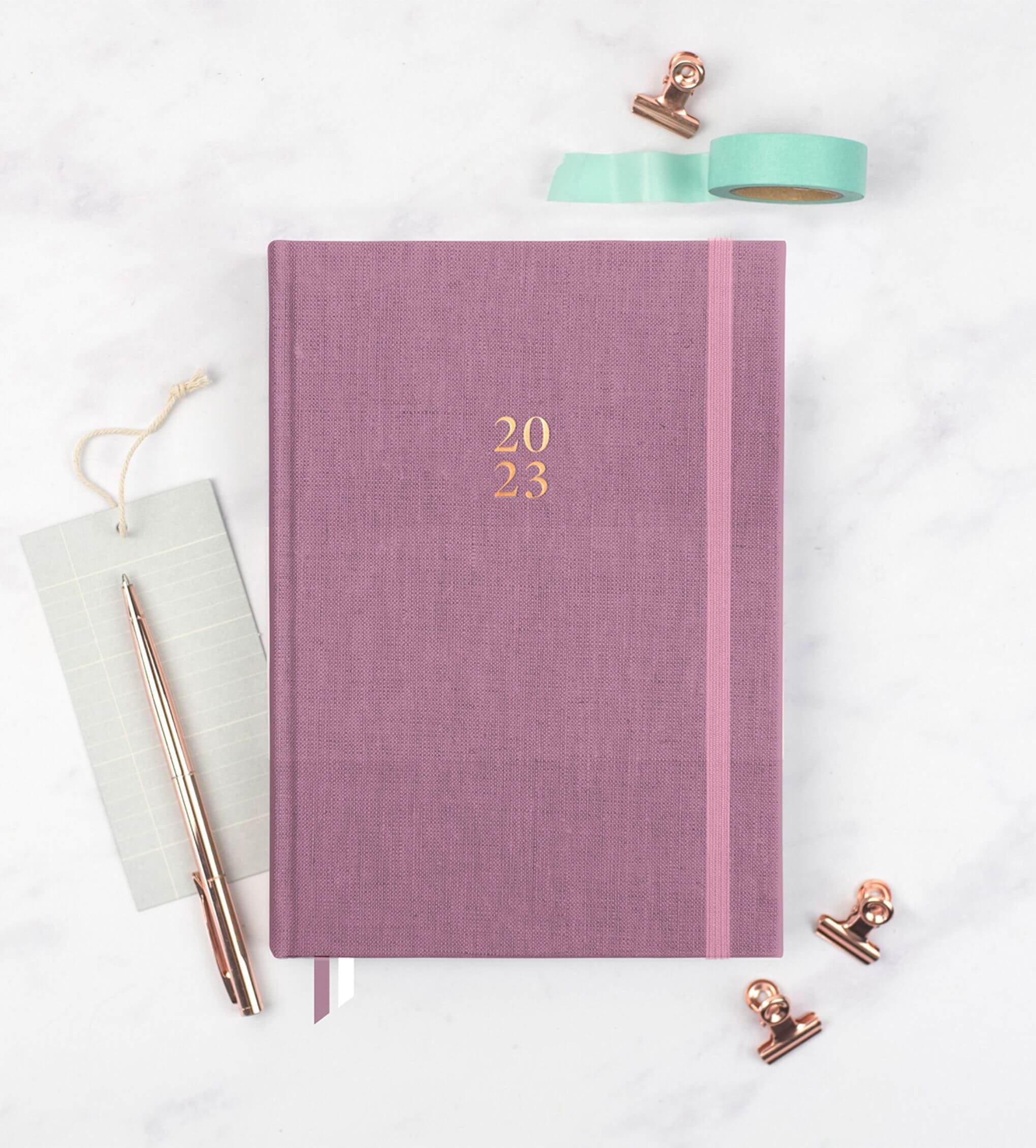 Ponderlily Weekly Planner 2023 in mauve color, featuring a stylish design with motivational quotes and organized sections for planning.