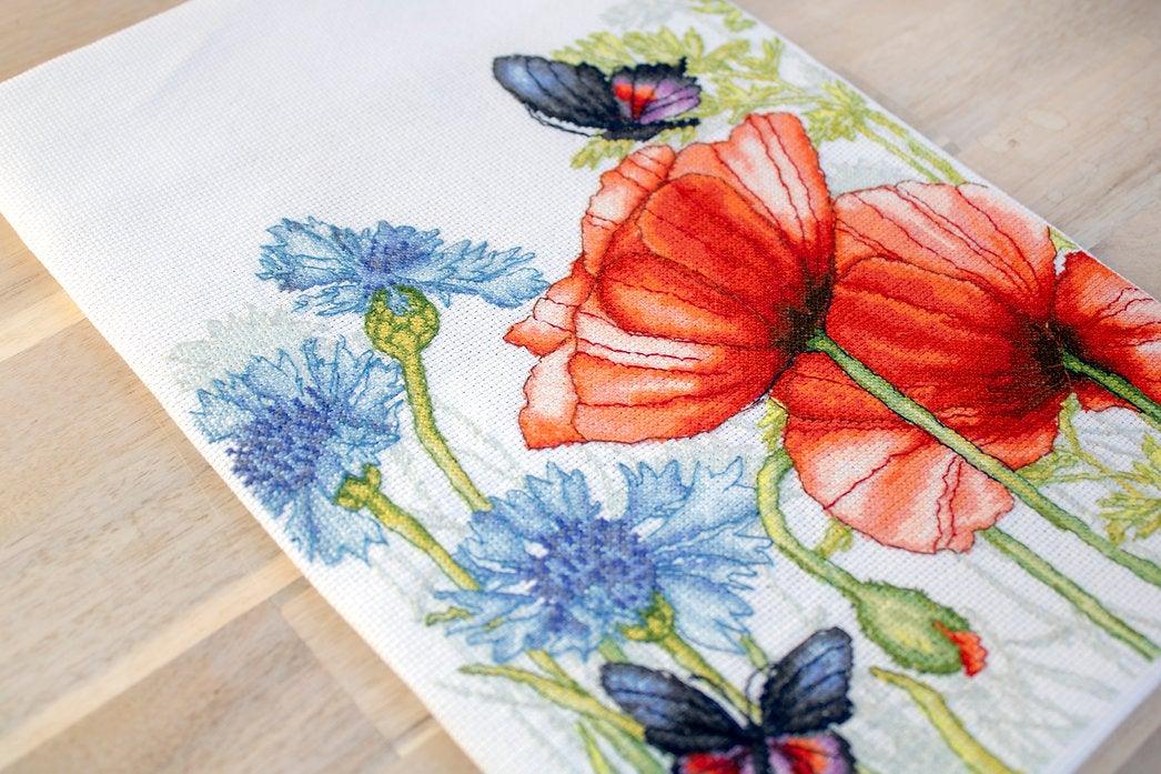 Poppies and Butterflies counted cross-stitch kit featuring vibrant red flowers and butterflies on Aida canvas.