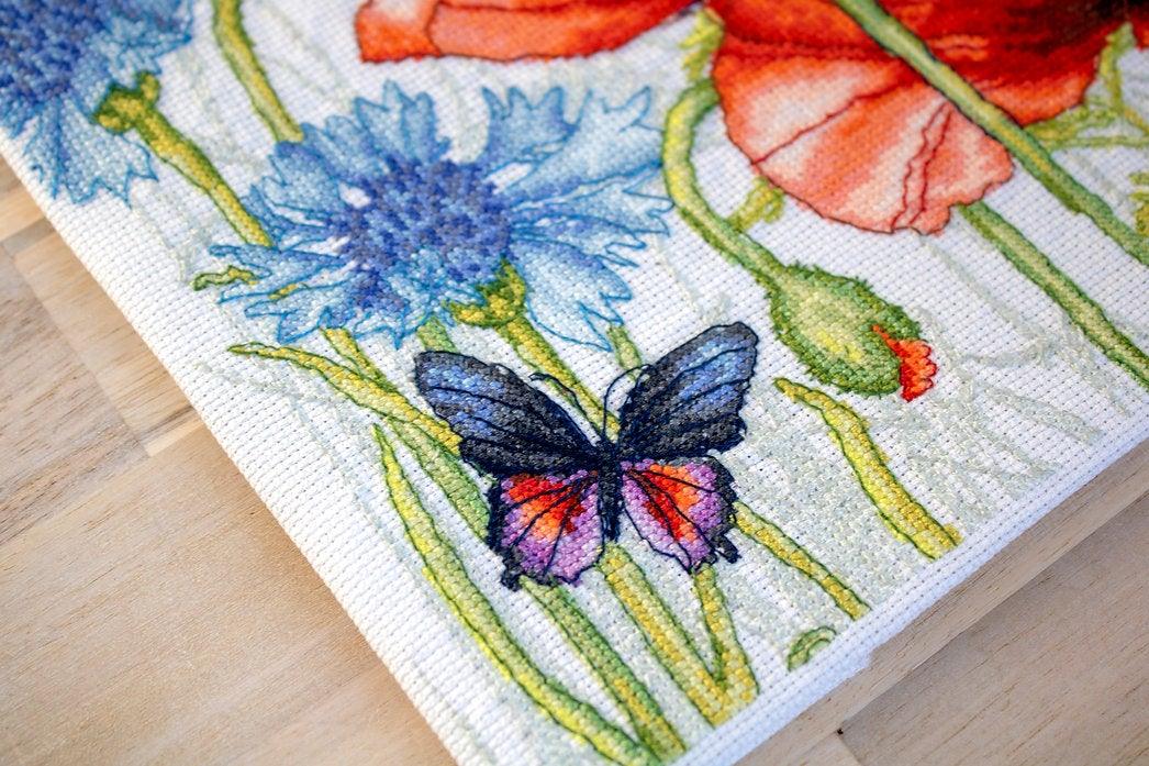 Poppies and Butterflies counted cross-stitch kit featuring vibrant red flowers and butterflies on Aida canvas.