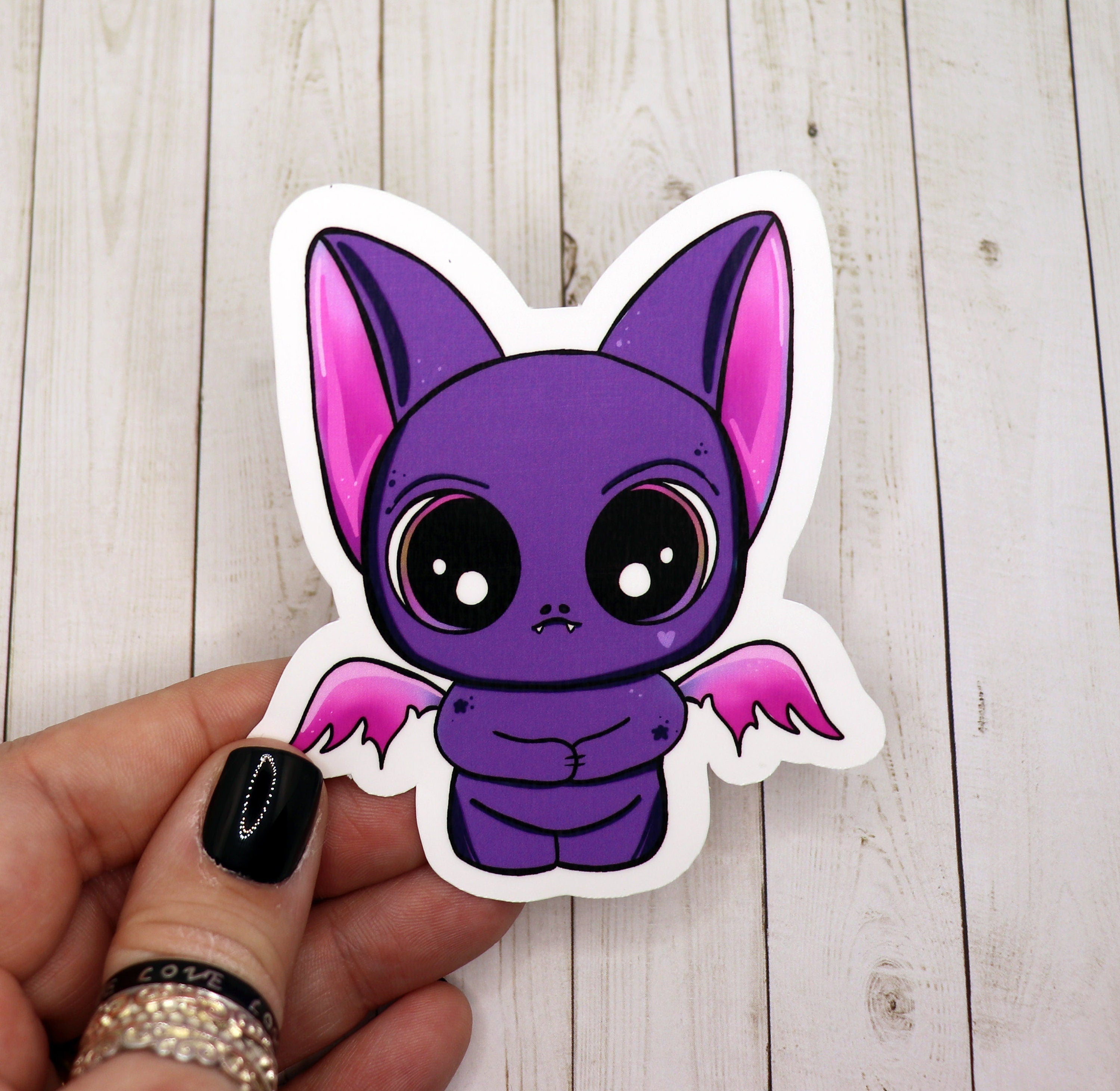 A vibrant purple bat sticker on a white background, showcasing its unique design and matte finish.