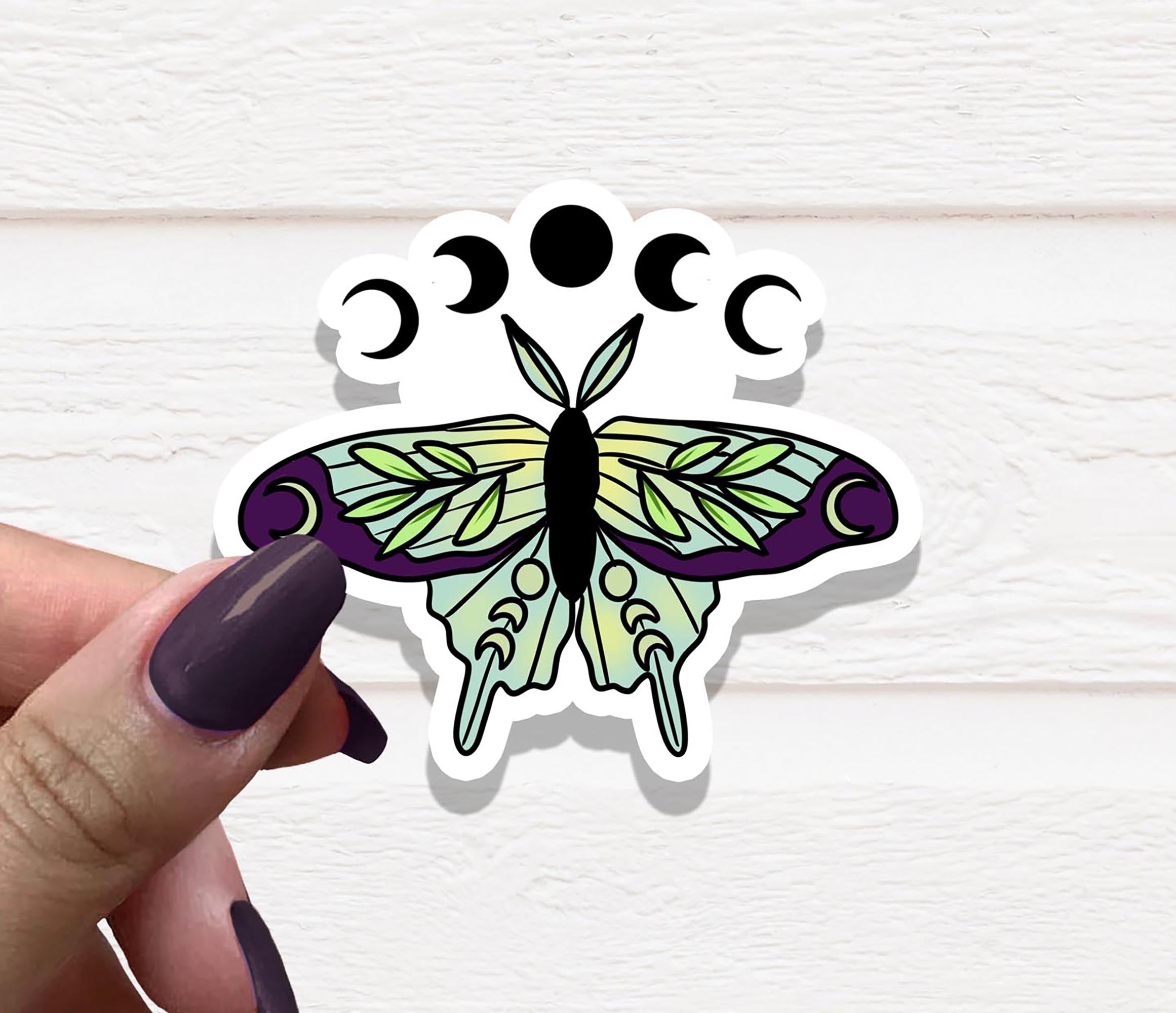 Purple Green Lunar Moth Vinyl Sticker on a white background, showcasing its vibrant colors and intricate design.