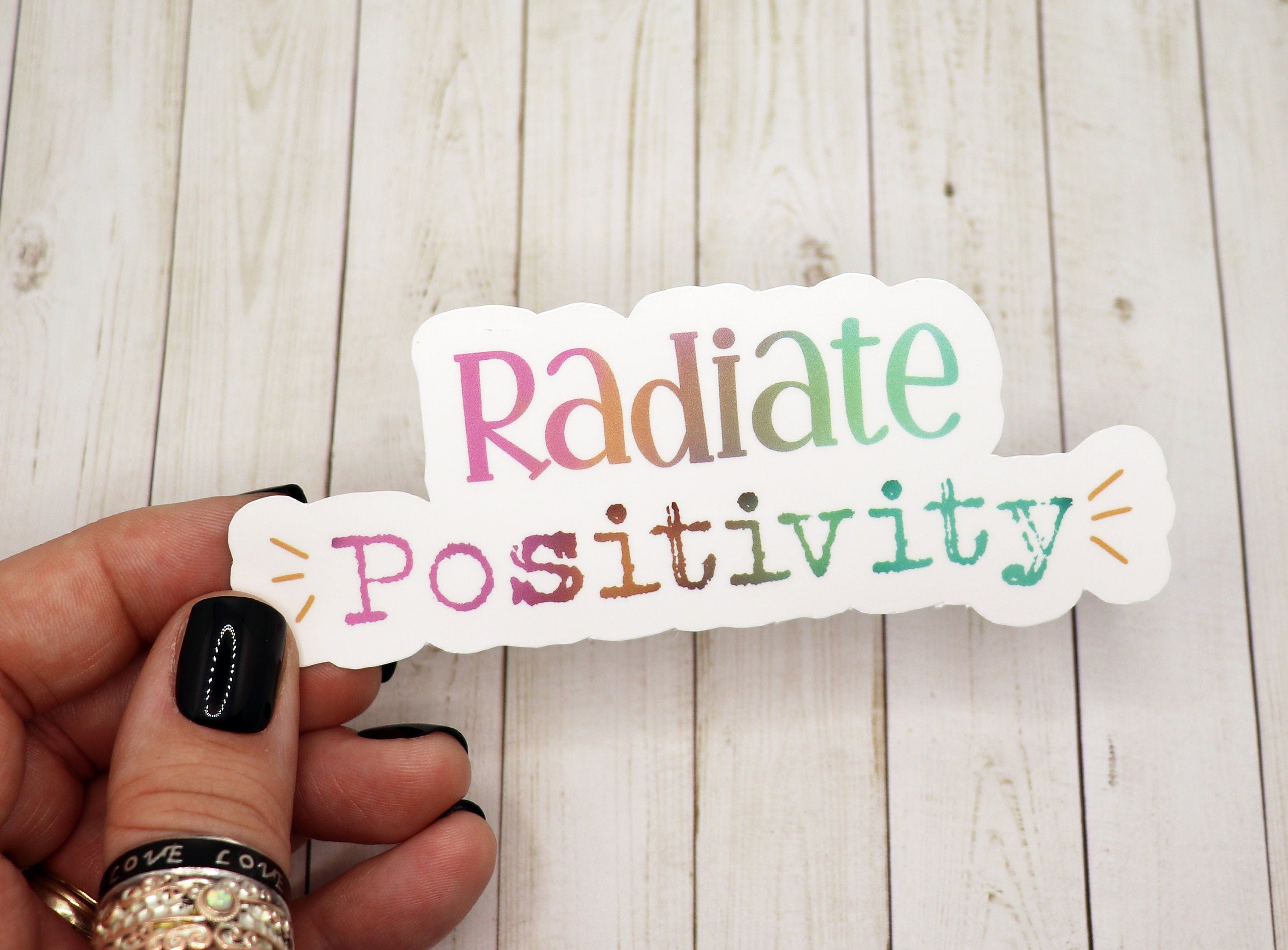 Radiate Positivity vinyl sticker featuring vibrant colors and a cheerful design, perfect for personalizing various items.