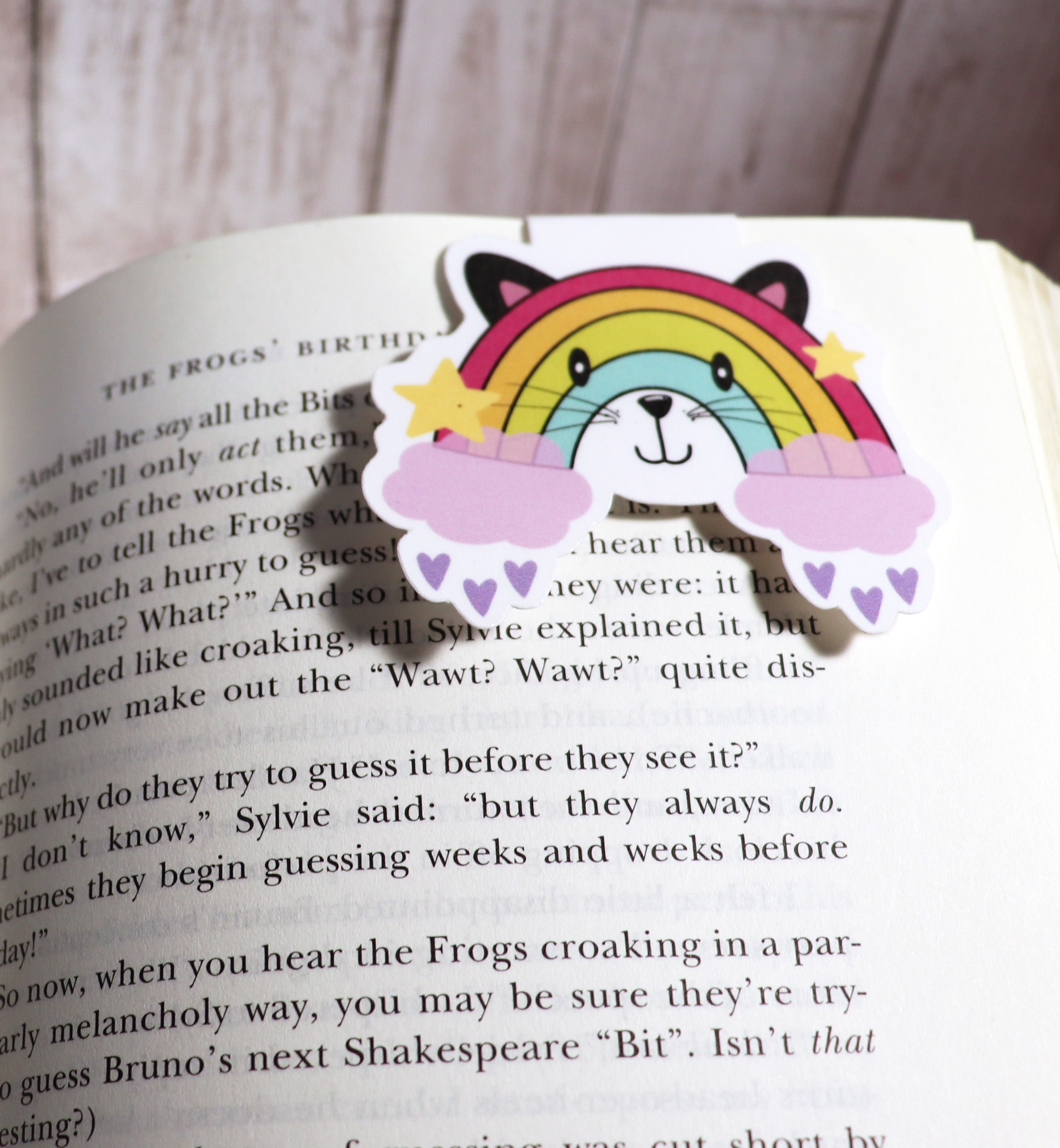 A colorful Rainbow Cat Bookmark featuring a vibrant cat design, double-sided, with strong magnets for secure page holding.