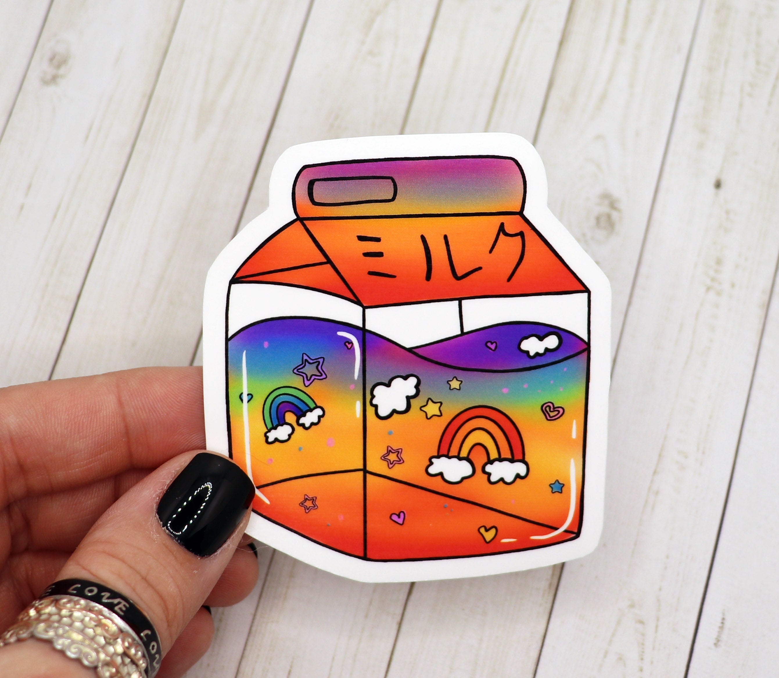 Colorful Rainbow Milk Carton Sticker on a white background, showcasing its vibrant design and matte finish.