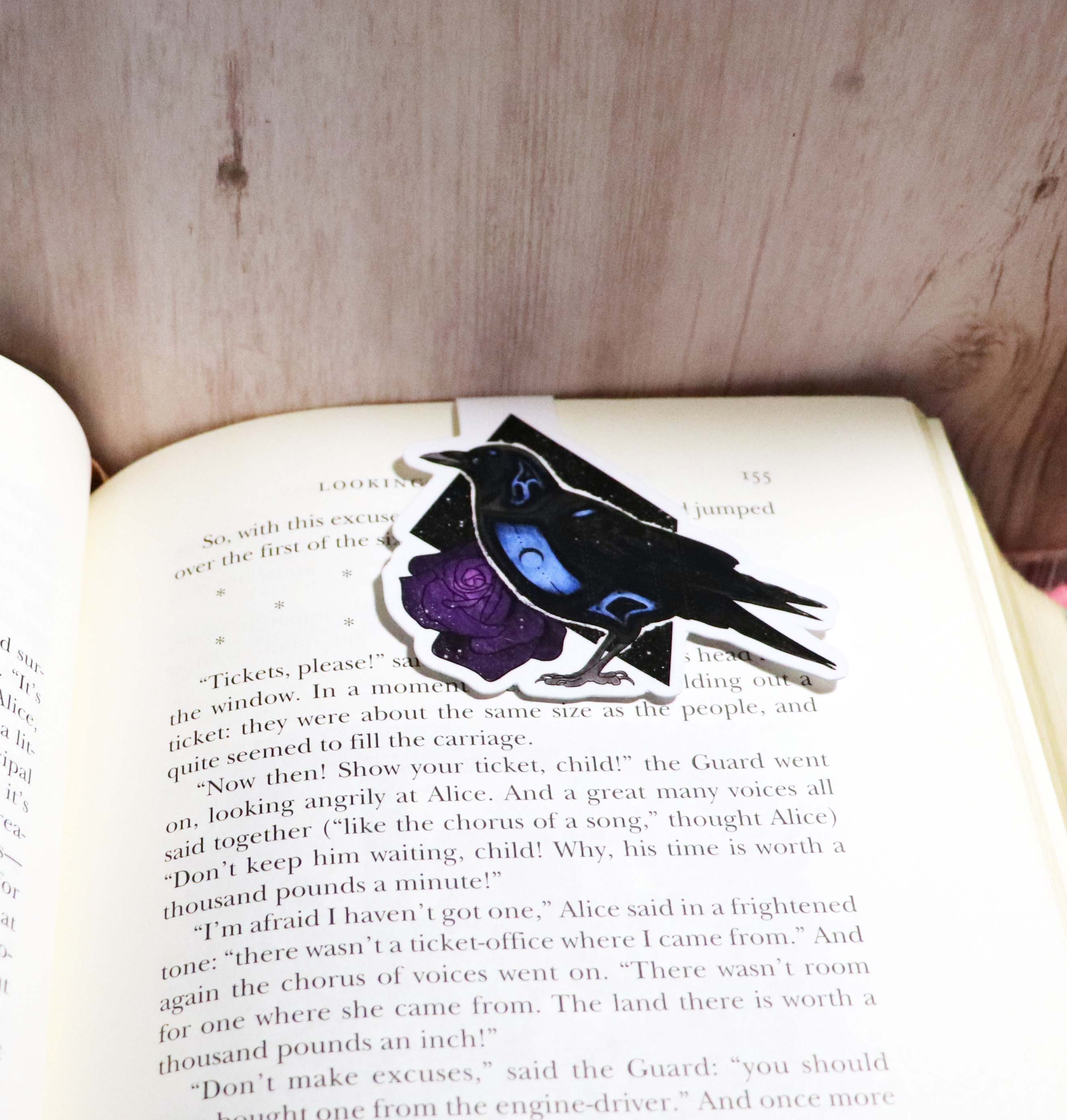 A beautifully designed Raven Bookmark, showcasing its double-sided feature and strong magnets, perfect for avid readers.