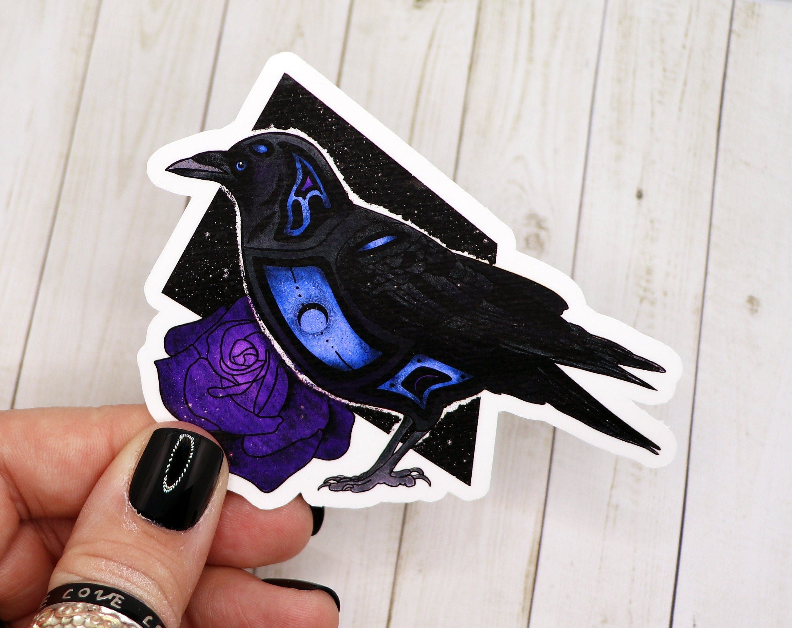 A detailed raven sticker on a matte vinyl surface, showcasing its intricate design and vibrant colors.