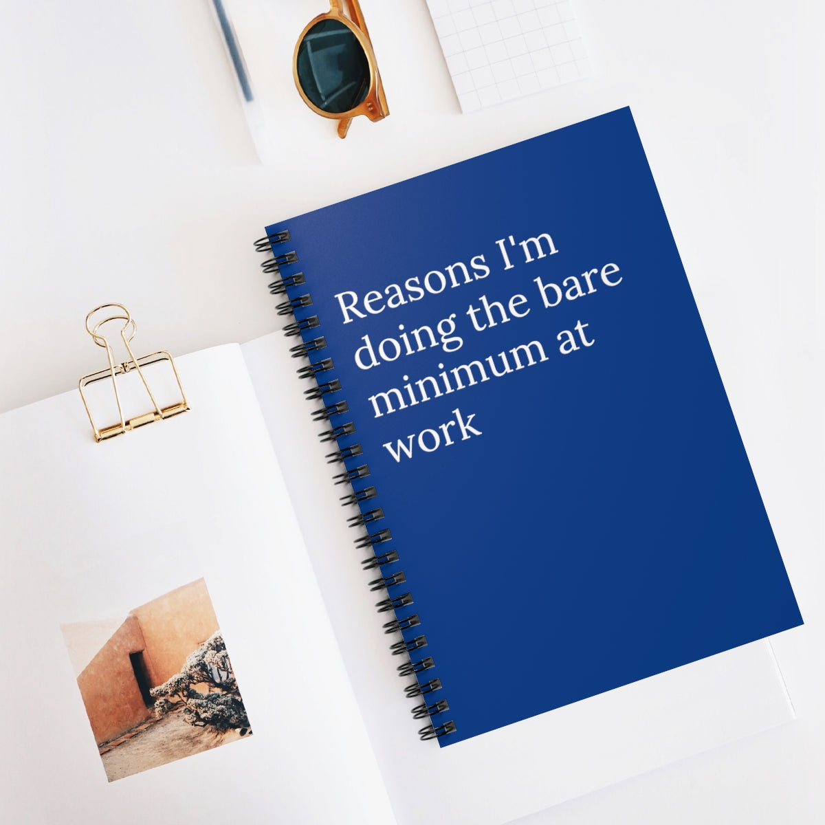 A humorous spiral notebook titled 'Reasons I'm Doing the Bare Minimum at Work' with ruled pages, perfect for office use.