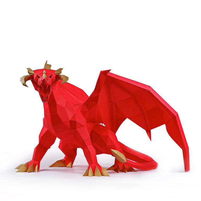 A stunning red and gold paper dragon model in a predatory stance with wings spread, showcasing intricate details and craftsmanship.